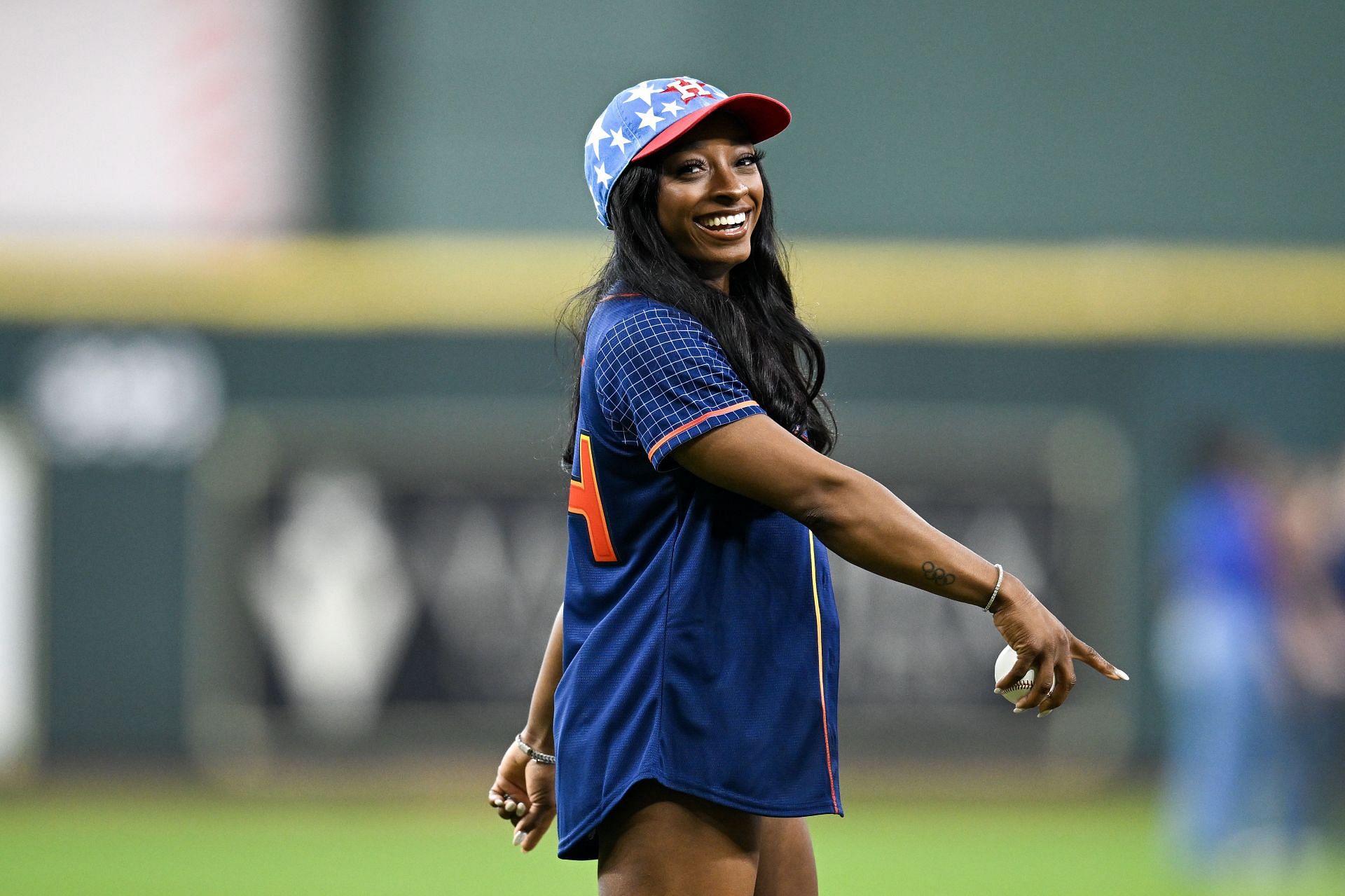 Simone Biles throws out the ceremonial first pitch prior to the MLB game between the Houston Astros and Kansas City Royals at Minute Maid Park in Houston, Texas. (Photo by Getty Images)