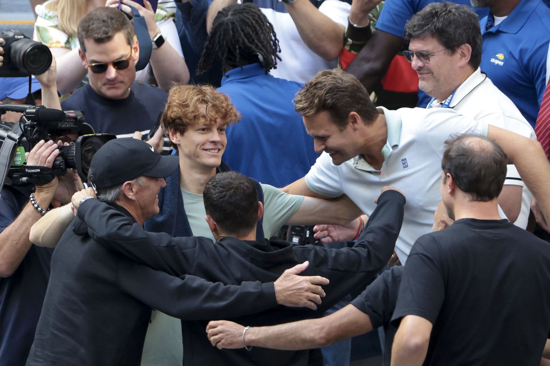 Jannik Sinner (center, olive T-shirt) with his tennis team after winning the 2024 US Open | Getty Images