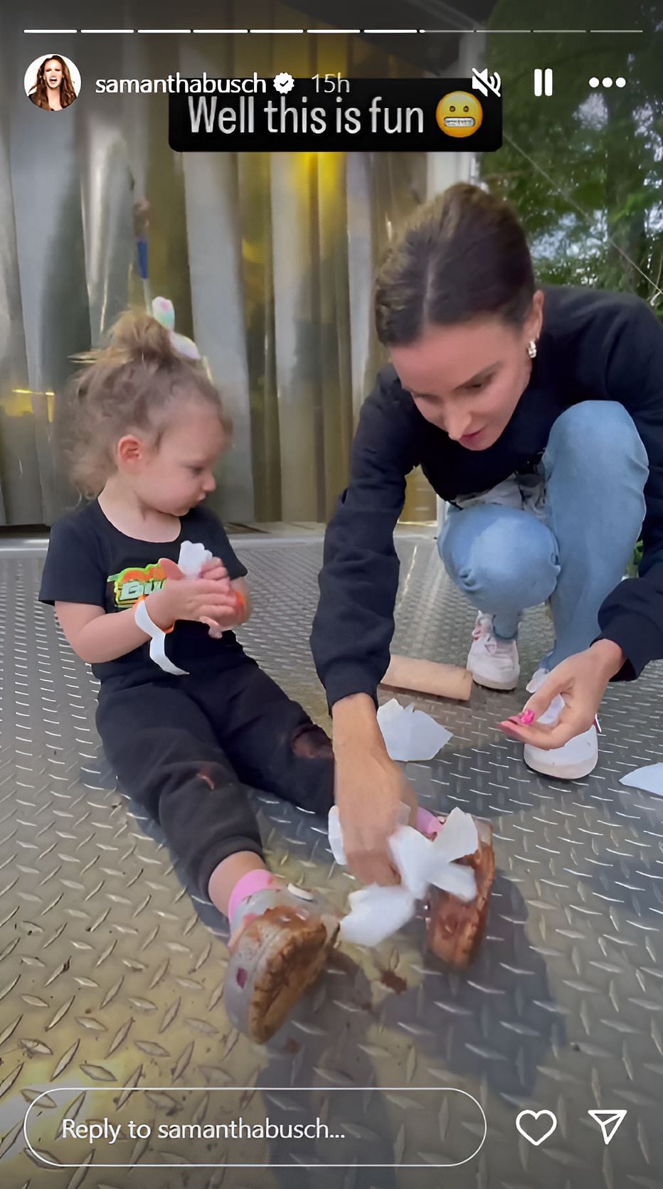 Samantha Busch wiping the mud off her daughter Lennix&#039;s Crocs (photo credit: @samanthabusch on Instagram)