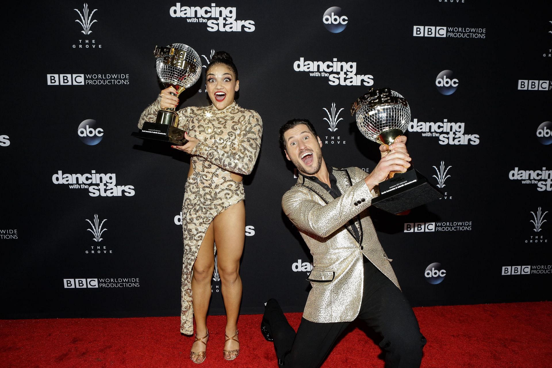 Laurie Hernandez and her dance partner with their DWTS trophy (Source: Getty)