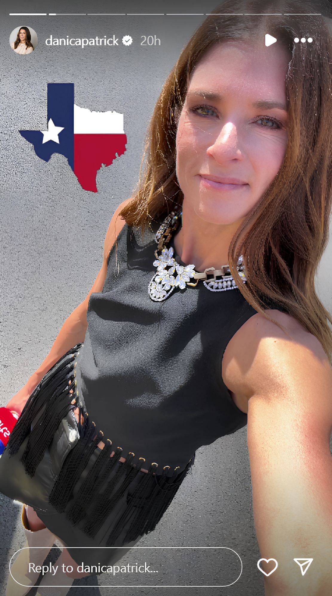 Danica Patrick posing in a fringed black dress paired with bold necklace (Source: @danicapatrick on Instagram)