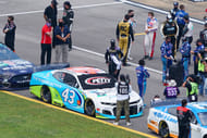 Former NASCAR driver Richard Petty (middle, in cowboy hat) stands near the car of NASCAR Cup Series driver Bubba Wallace (43) Source: Imagn Images