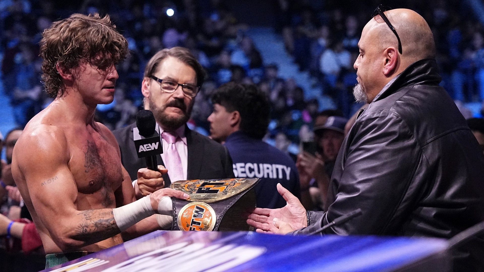 Taz and son Hook with the FTW Championship on AEW Dynamite