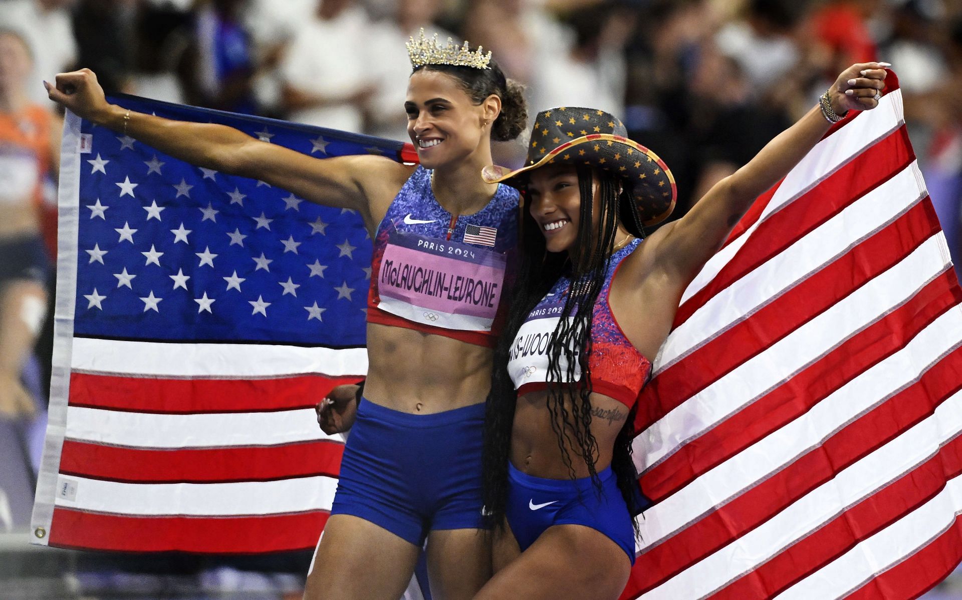 Tara Davis-Woodhall of the USA posing with Olympic champion Sydney McLaughlin-Levrone after winning her long jump event at the Paris Olympics [Image Source: Getty]