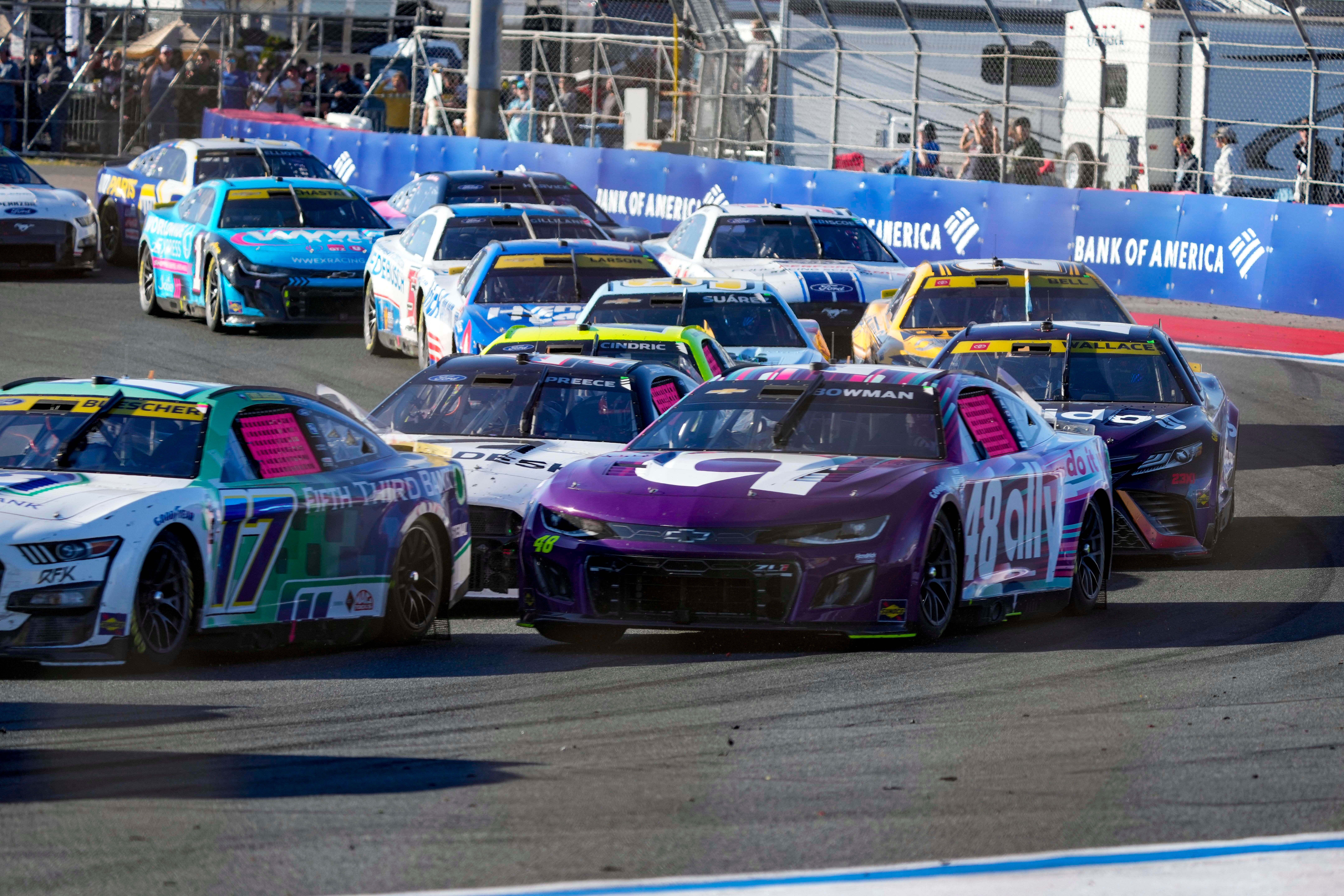 Oct 8, 2023; Concord, North Carolina, USA; Cars crowd into turn four after a restart during the Bank of America Roval 400 at Charlotte Motor Speedway Road Course. NASCAR: Bank of America ROVAL 400 - Source: Imagn