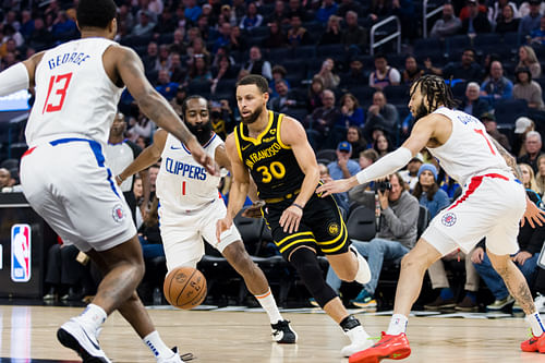 Golden State Warriors guard Stephen Curry drives past LA Clippers guard James Harden and guard Amir Coffey at Chase Center. Photo Credit: Imagn