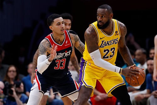 Los Angeles Lakers forward LeBron James holds the ball as Washington Wizards forward Kyle Kuzma defends at Capital One Arena. Photo Credit: Imagn