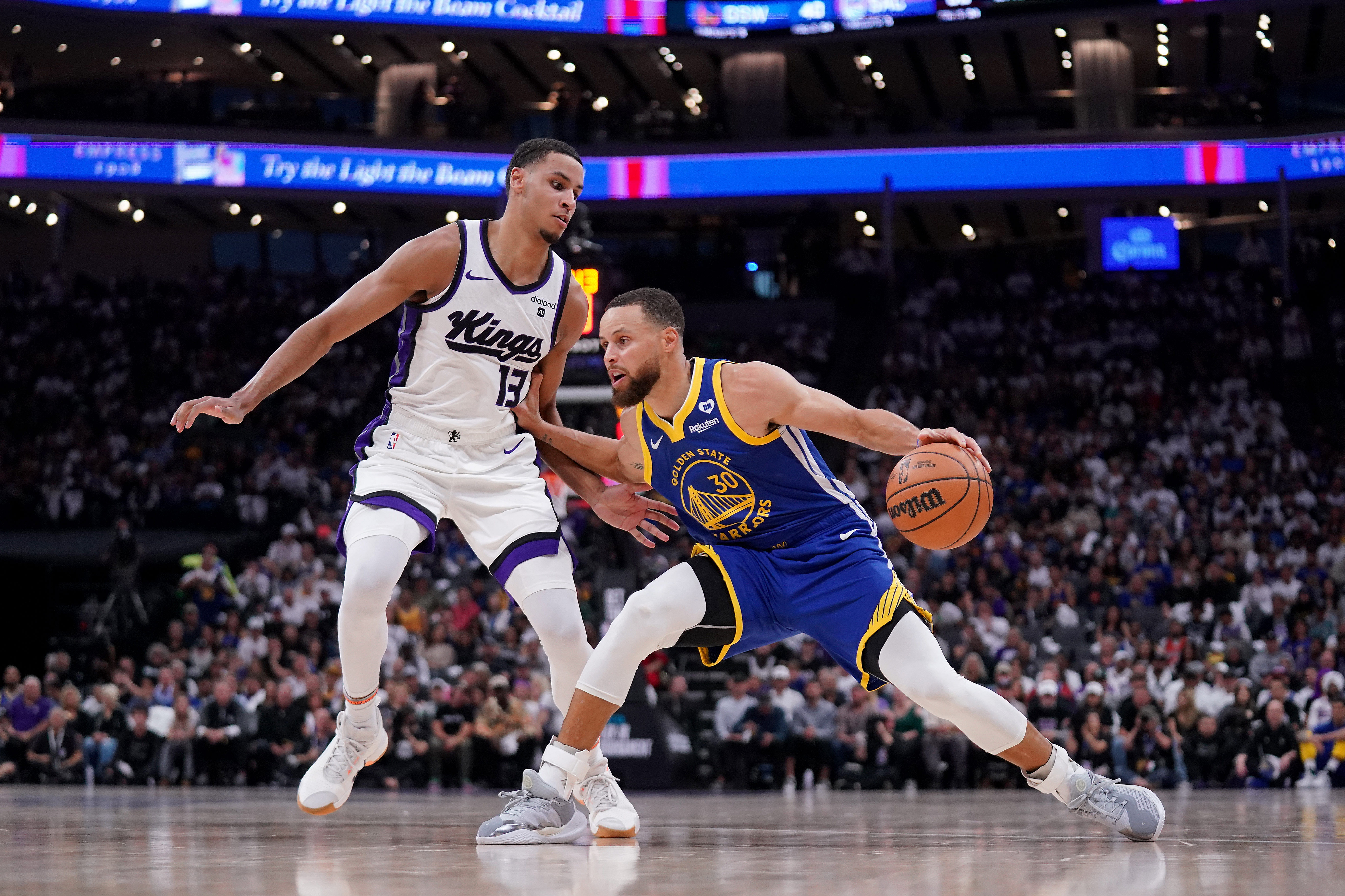 Golden State Warriors guard Stephen Curry dribbles the ball with Sacramento Kings forward Keegan Murray gurding him at the Golden 1 Center. Photo Credit: Imagn