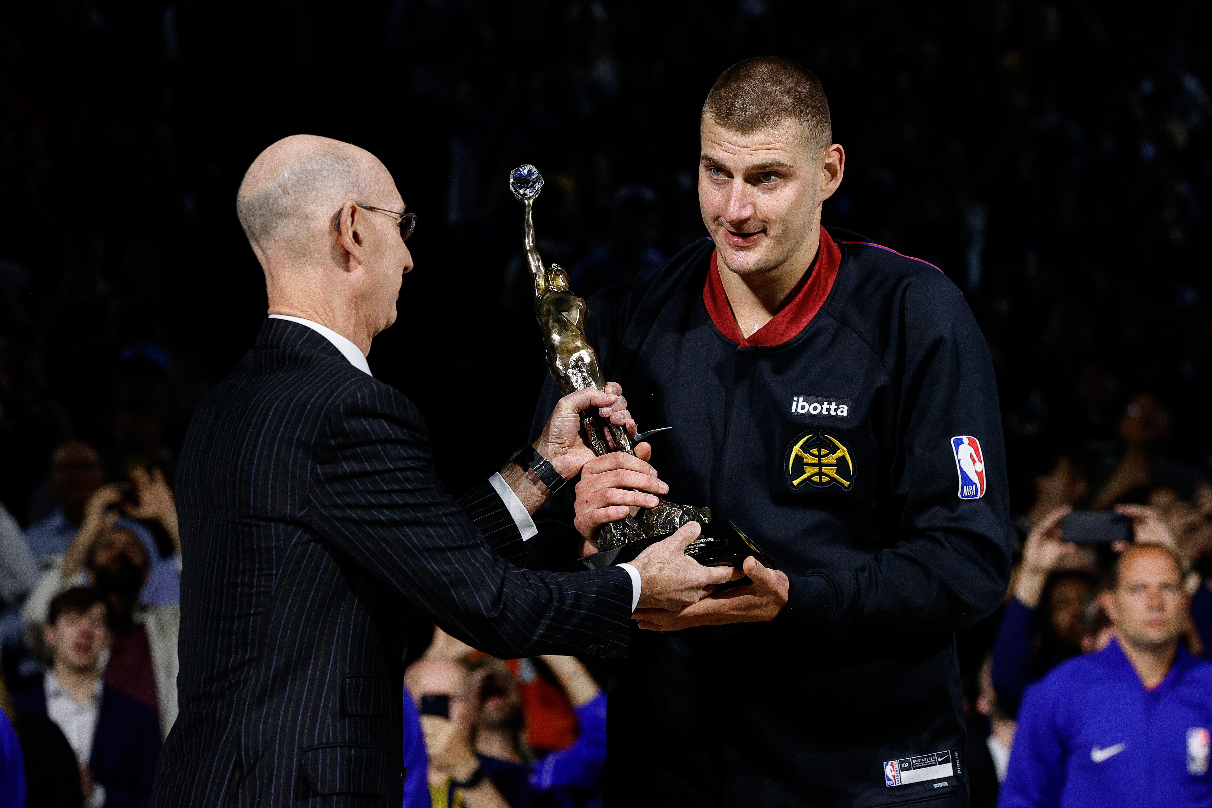 NBA commissioner Adam Silver presents Denver Nuggets center Nikola Jokic the KIA NBA MVP trophy at Ball Arena. Photo Credit: Imagn