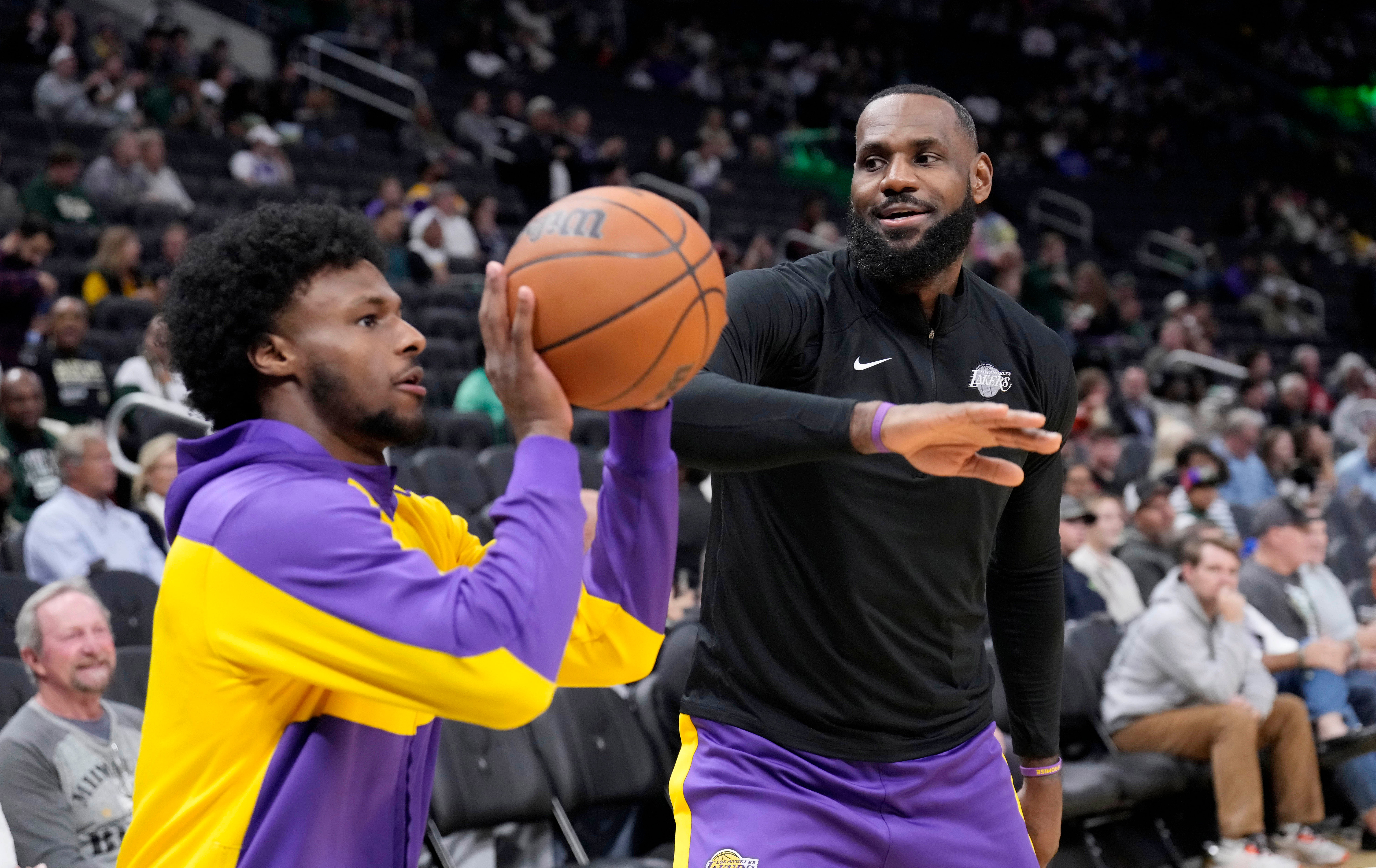 Los Angeles Lakers forward LeBron James goofs around with his son guard Bronny James during warm ups at Fiserv Forum. Photo Credit: Imagn