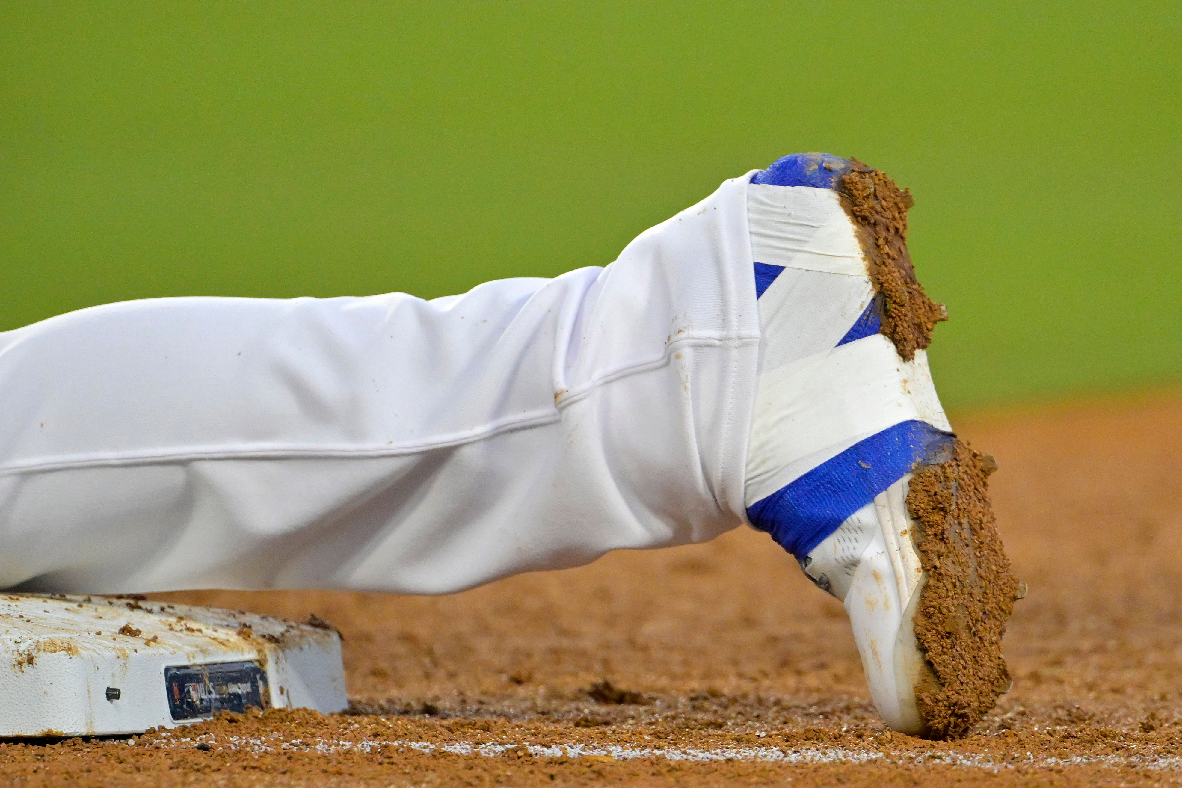 Freddie Freeman puts layers of strappings over his cleats to support his injured ankle (Image Source: IMAGN)