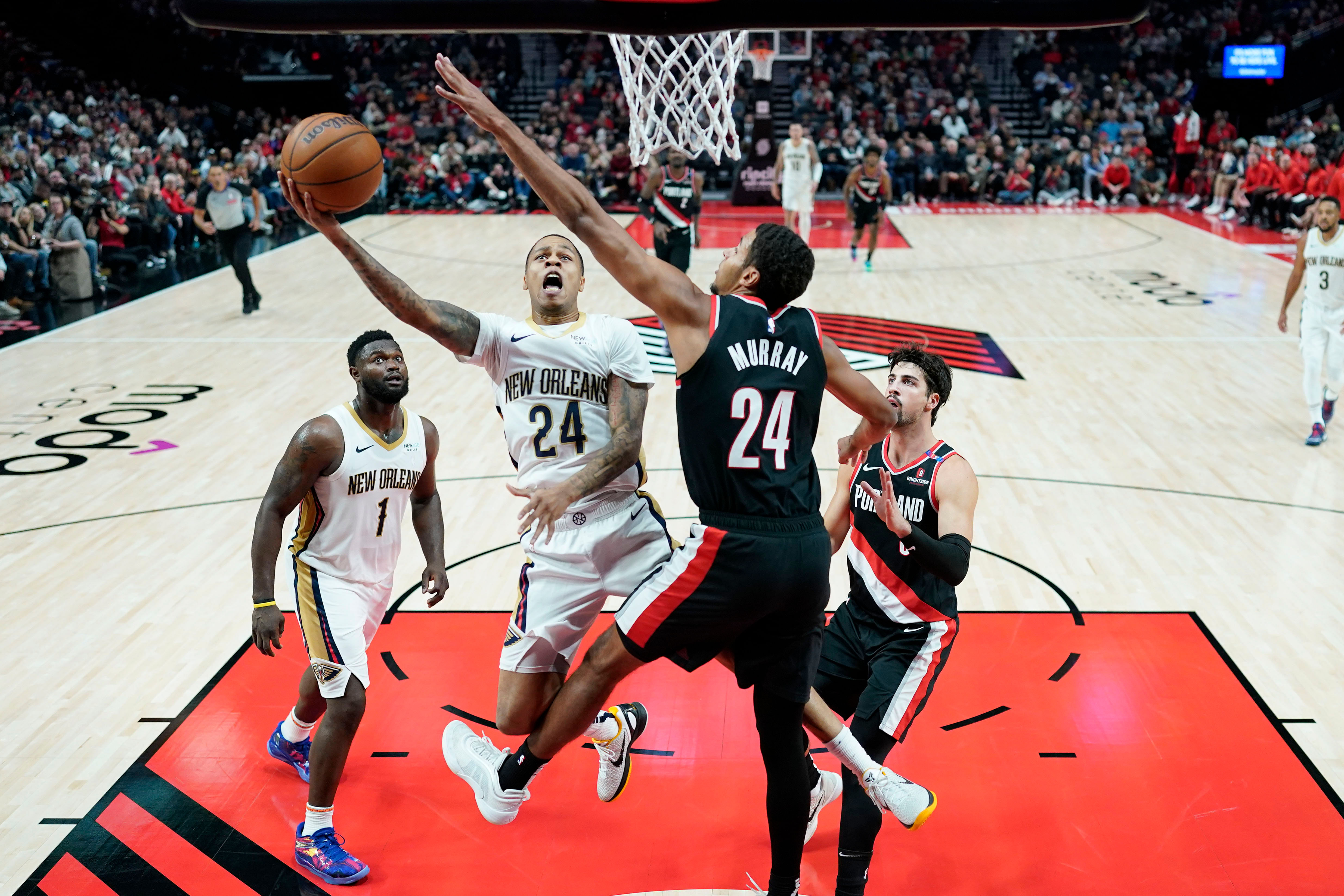 New Orleans Pelicans guard Jordan Hawkins shoots the ball against Portland Trail Blazers forward Kris Murray at Moda Center. Photo Credit: Imagn