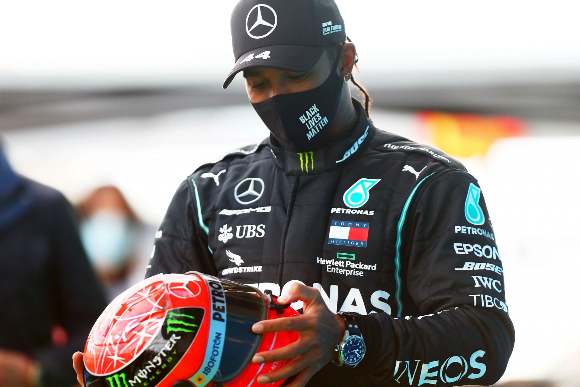 Lewis Hamilton celebrates after being presented with a helmet of Michael Schumacher at the F1 Eifel Grand Prix - Source: Getty Images