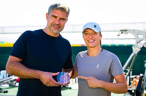 Wiktorowski poses next to Swiatek with the 2023 WTA Coach of the Year Award Image Source: Getty