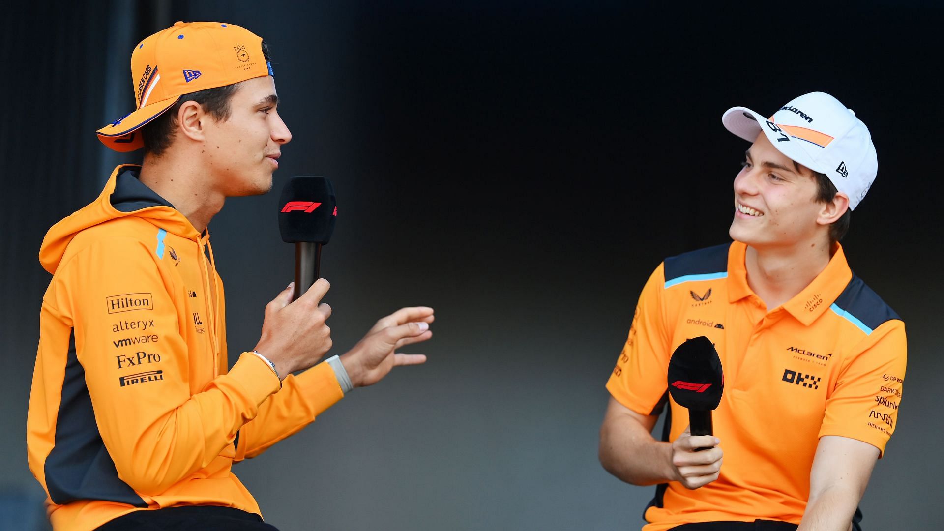 Lando Norris of Great Britain and McLaren and Oscar Piastri of Australia and McLaren talk on the fan stage (Source: Getty Images)