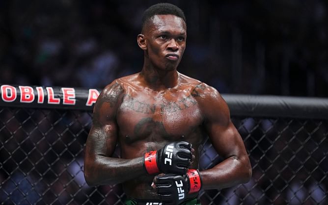 Israel Adesanya hits back with proof after fan asks why he dates "only white girls"