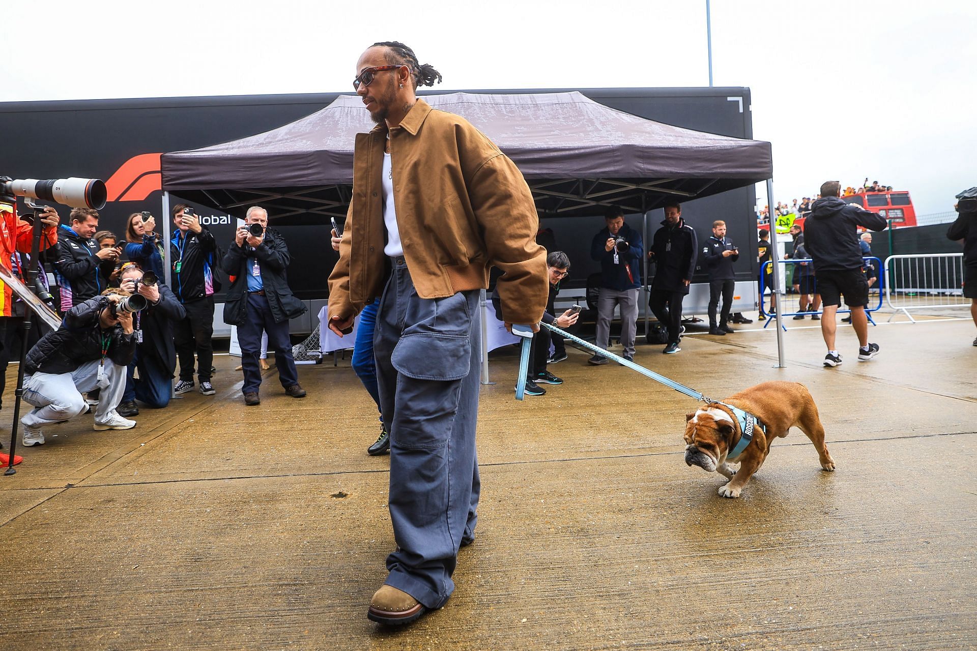 Lewis Hamilton of Great Britain and Mercedes arrives in the paddock with his dog Roscoe (Source: Getty Images)