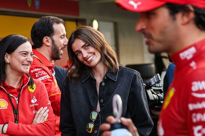 Carlos Sainz's girlfriend Rebecca can't take her eyes off the Spaniard while he gives post-race interview