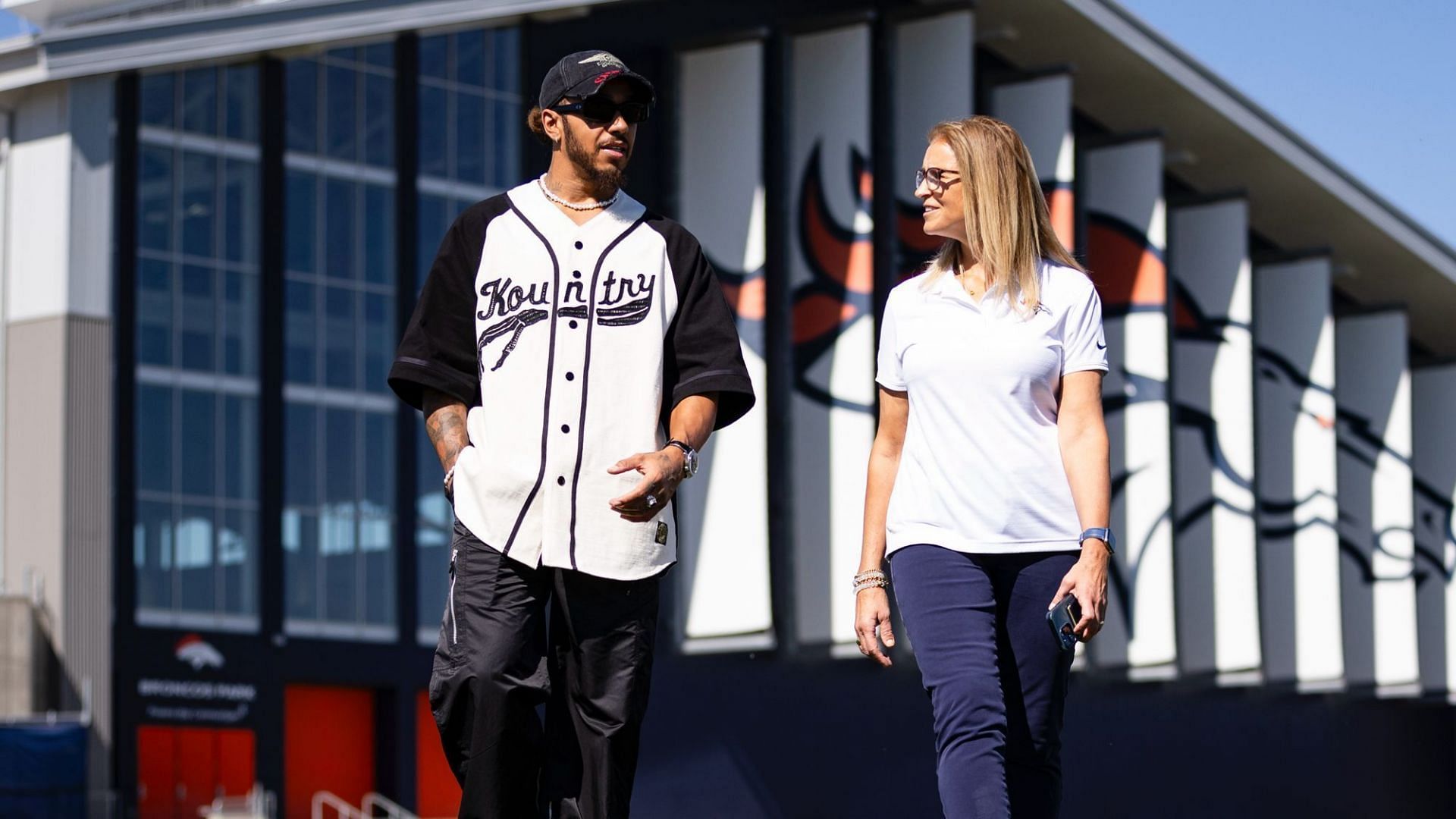 Lewis Hamilton in conversation with Carrie Walton Penner (@Broncos on X)