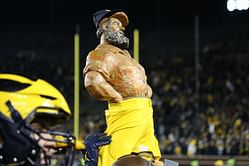 PHOTO: Future Michigan stars Andrew Babalola and Avery Gach celebrate win over in-state rivals with Paul Bunyan Trophy in the locker room