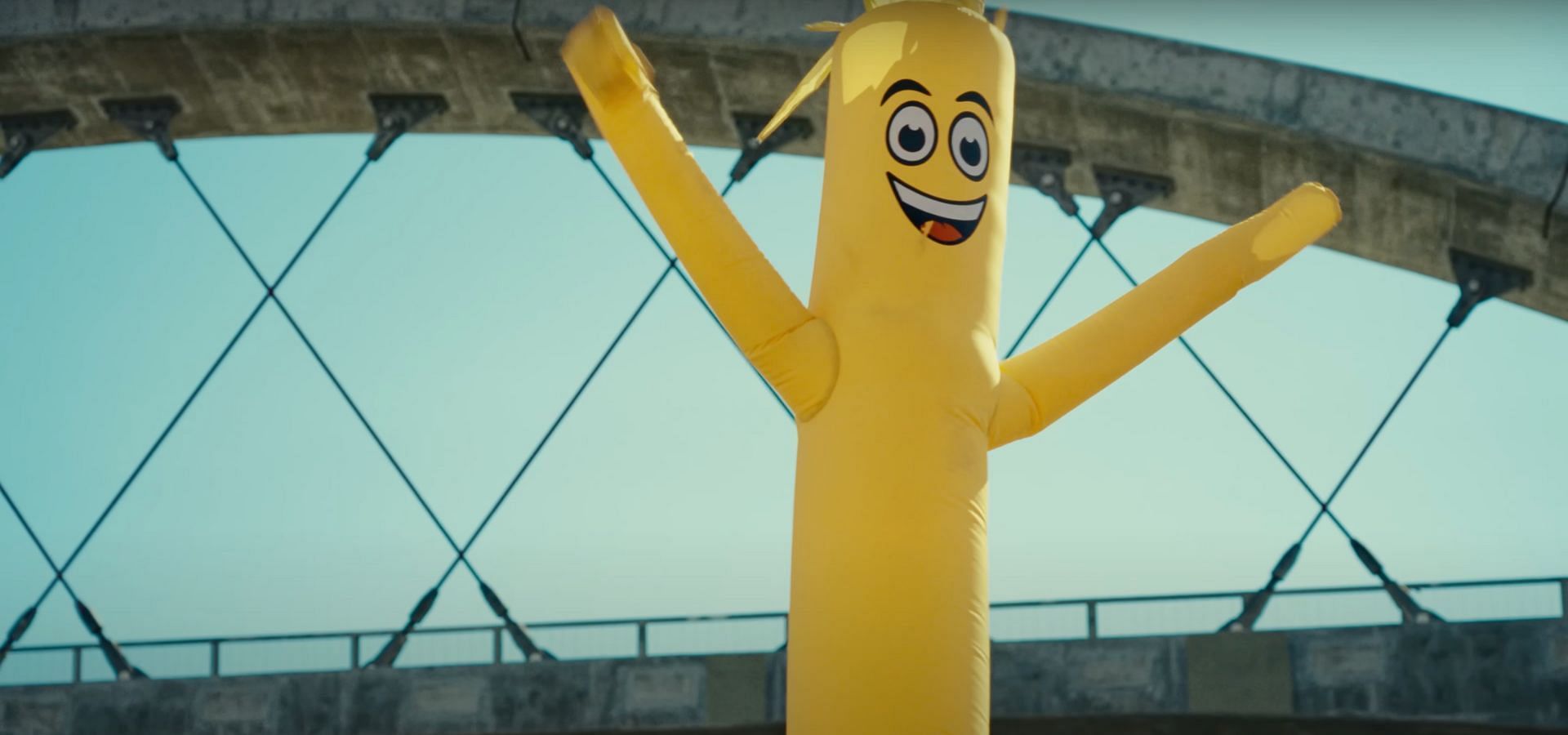 The inflatable tube man is similar to the &ldquo;IDOL&rdquo; MV (Image via YouTube/@HYBE LABELS)