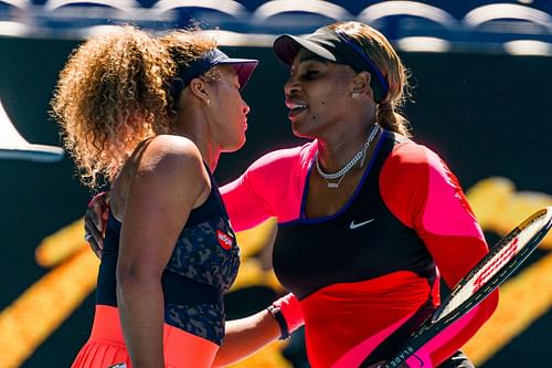 Naomi Osaka (L) and Serena Williams embrace each other.