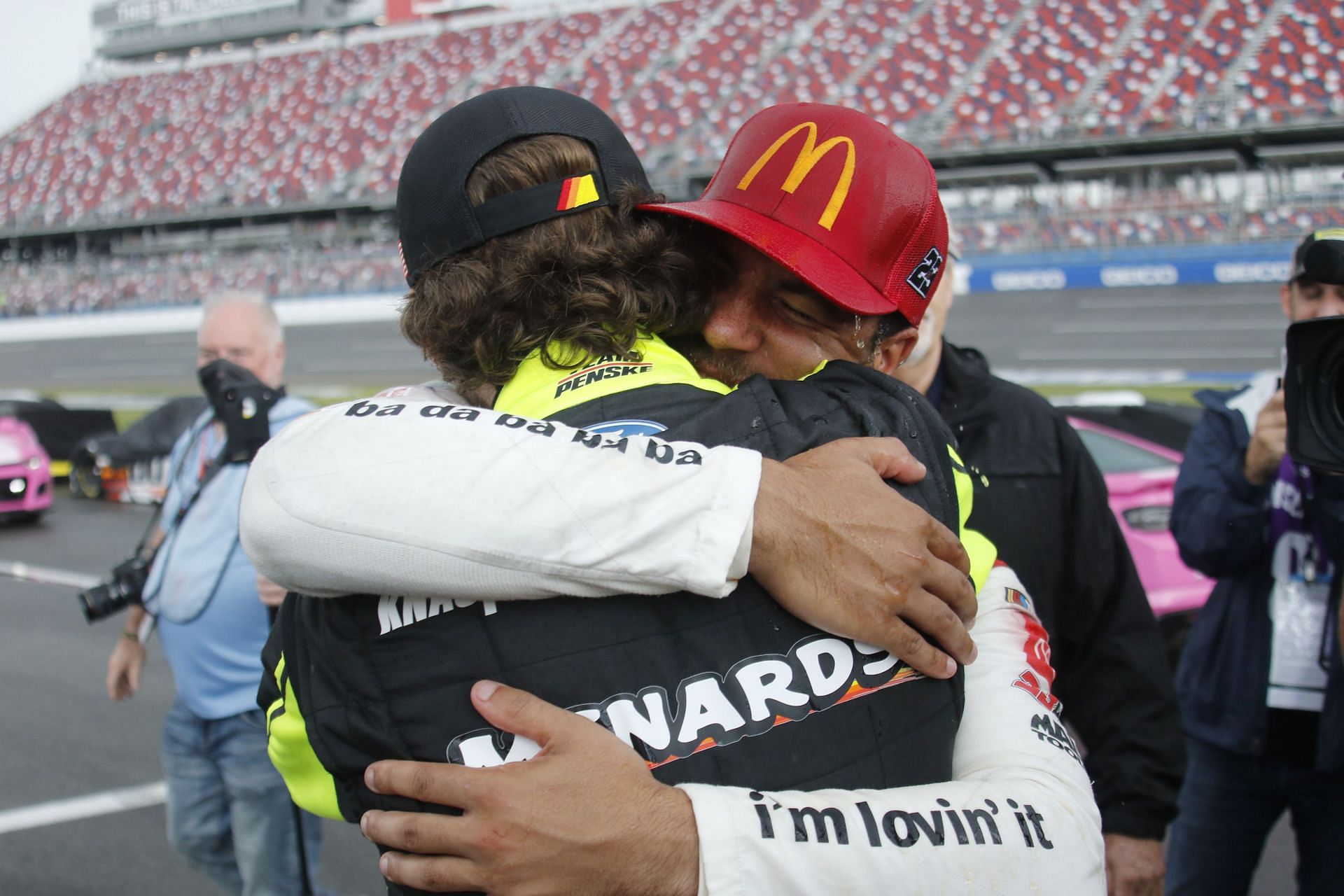 #23: Bubba Wallace, 23XI Racing, Toyota Camry McDonald&#039;s gets a hug from #12: Ryan Blaney, Team Penske, Ford Mustang Menards (Image via Getty)