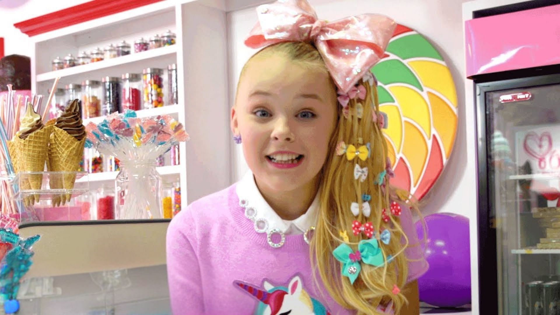 Still from the music video of Kid In A Candy Store (Image via YouTube/XOMG POP!)