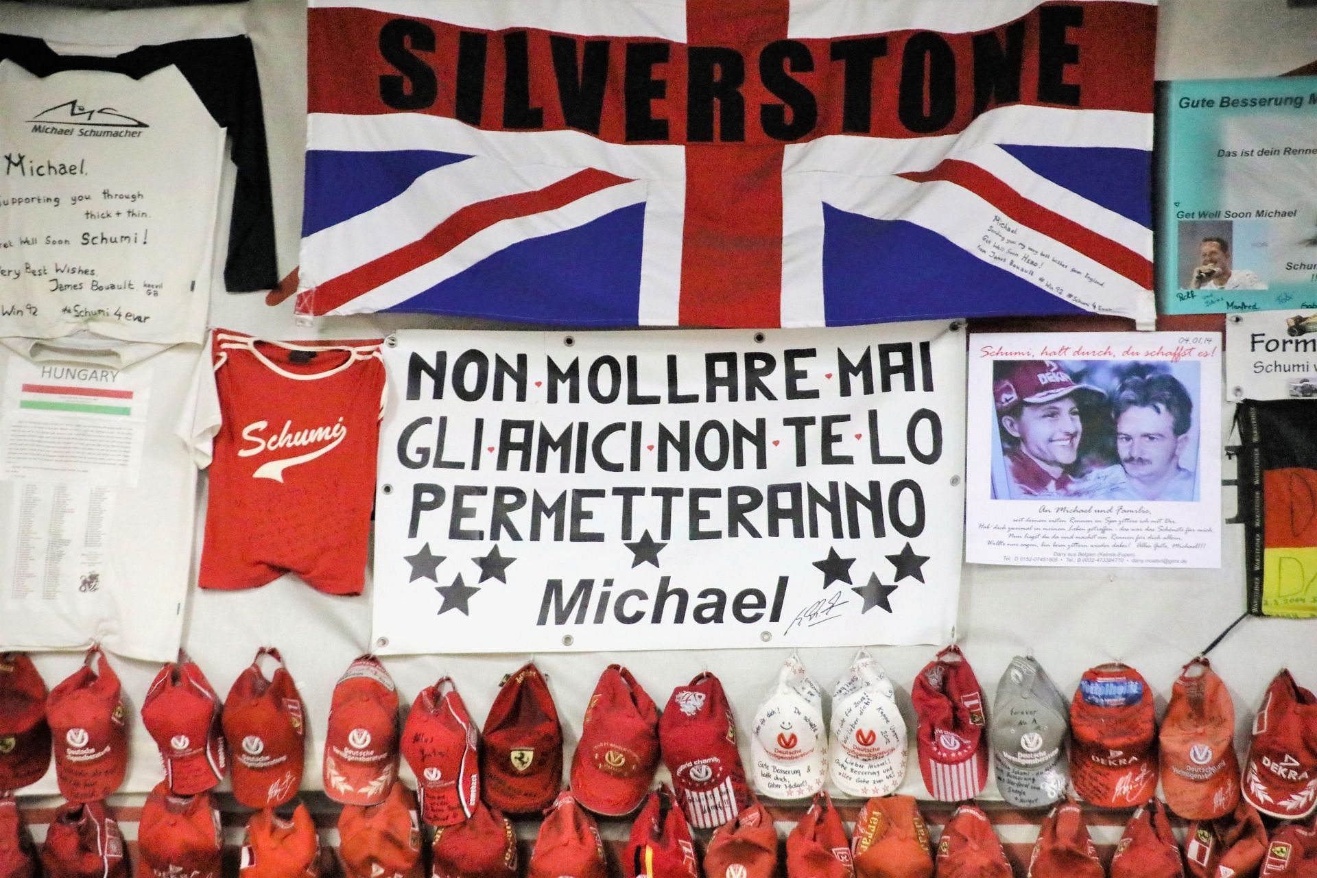 Fan articles on a wall in the Michael Schumacher Kart and Event Center hung after his skiing accident. Source: Getty Images