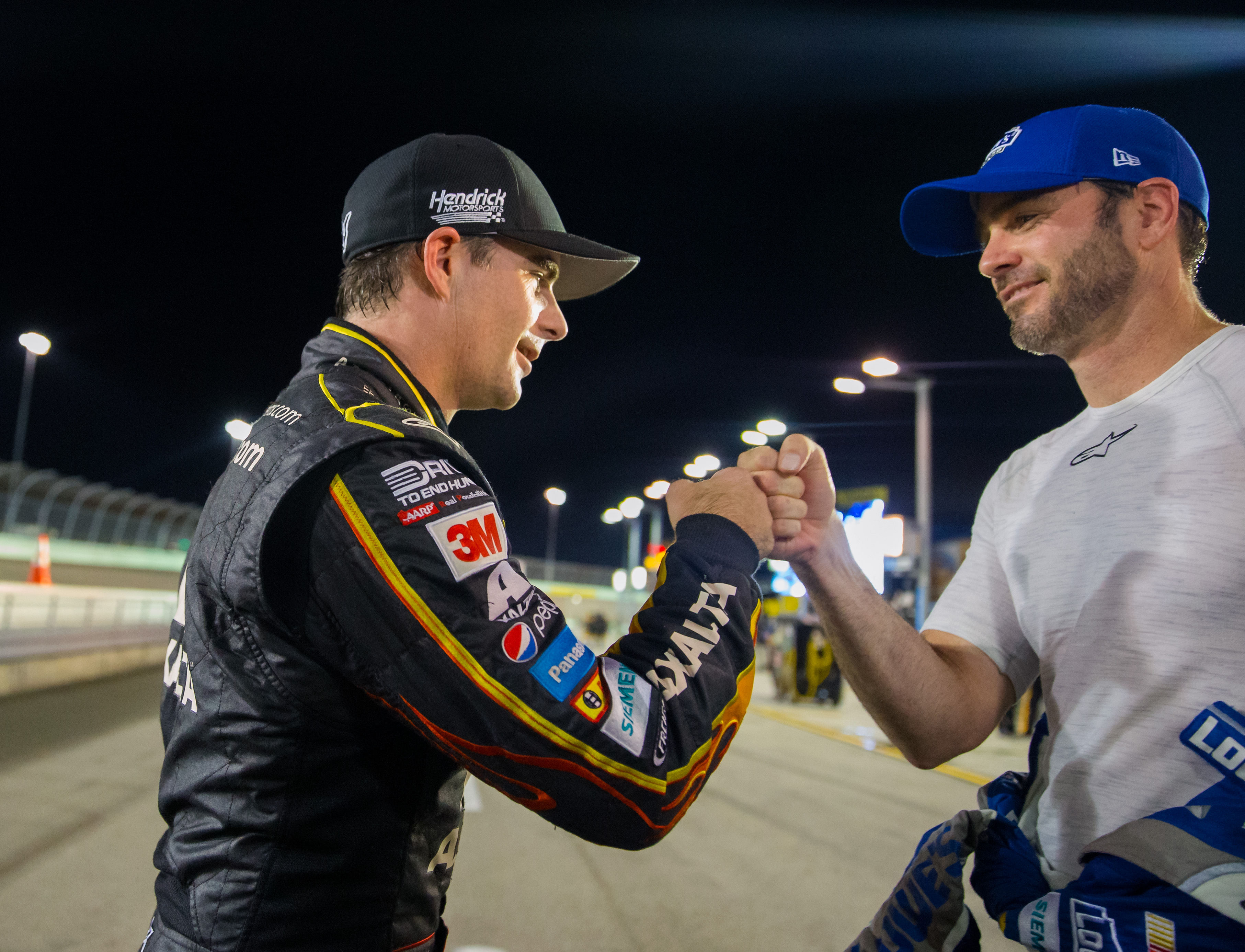 Jeff Gordon (left) fist bumps teammate Jimmie Johnson. Source: Imagn