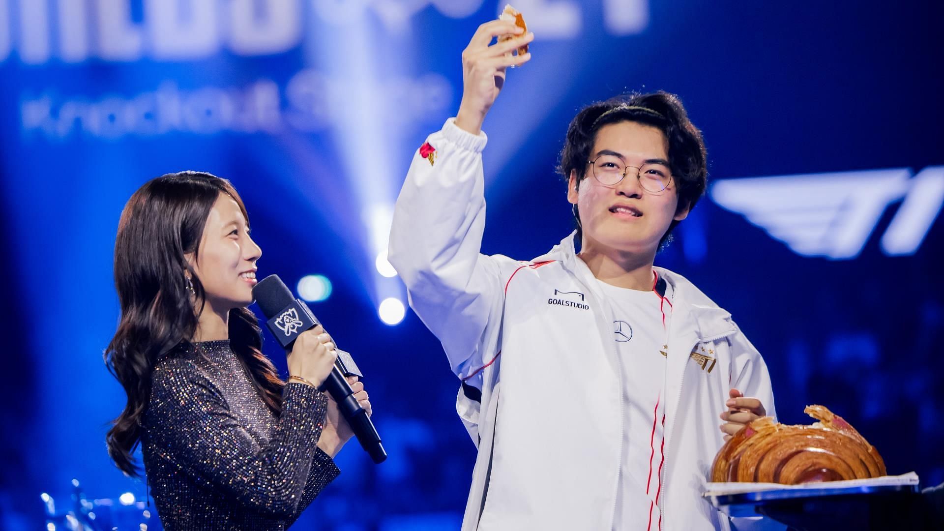 Gumayusi eating a croissant on stage in Paris, France (Image via Riot Games, LoL Esports)