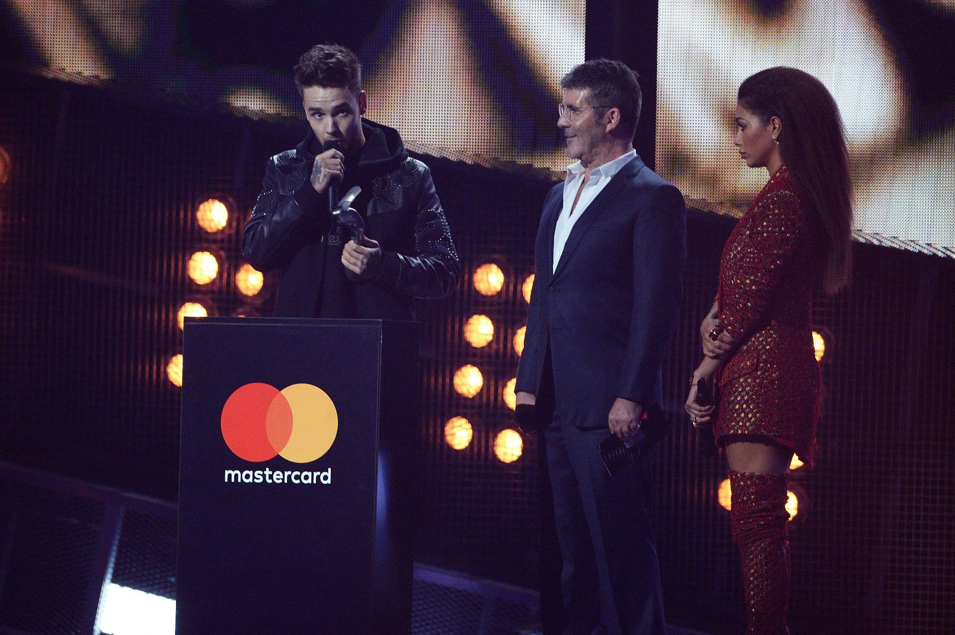 Liam Payne received an award on behalf of One Direction from Simon Cowell in 2017, (Photo by Dave J Hogan/Getty Images)