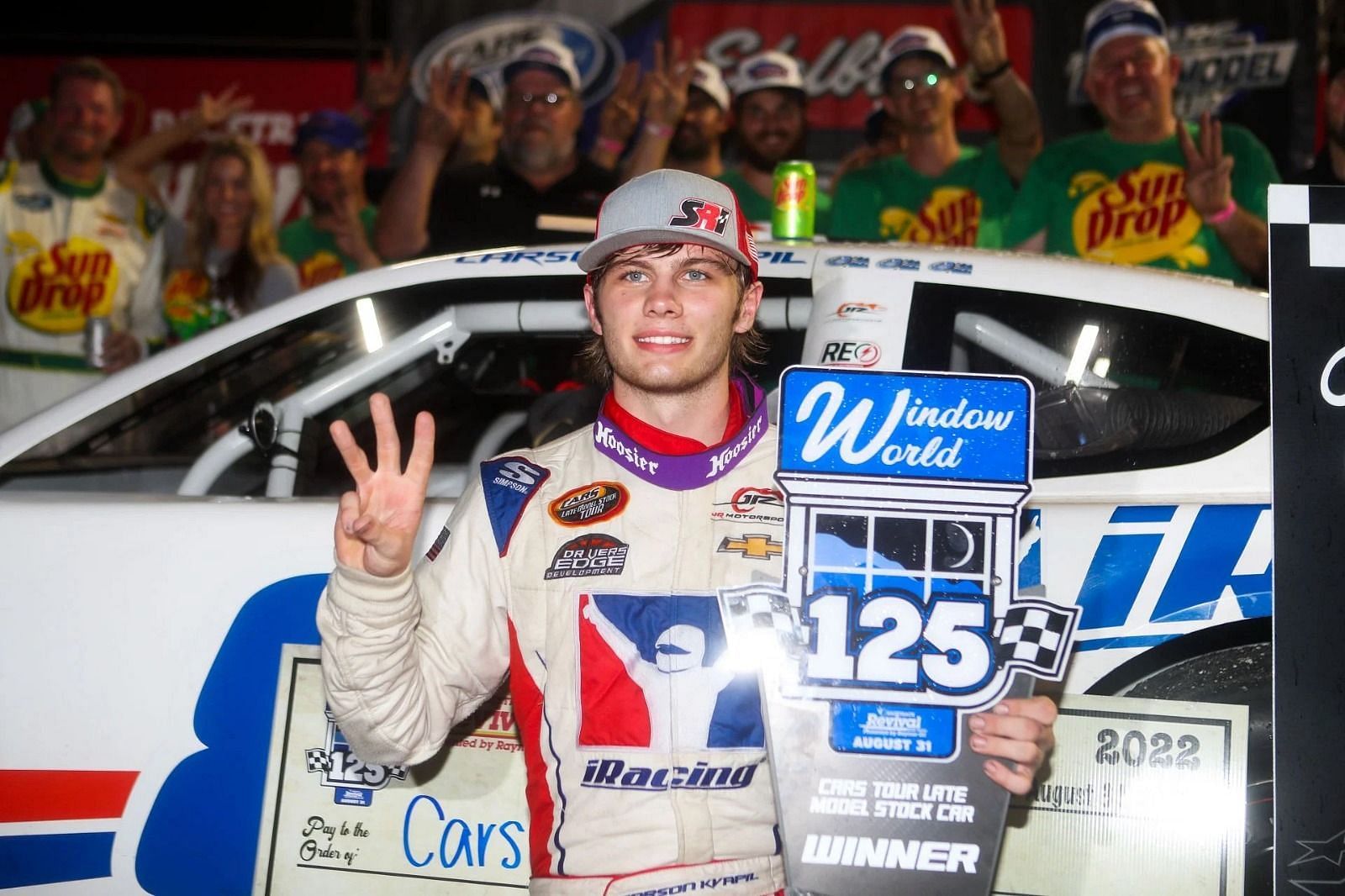 Carson Kvapil (8) poses for a photo after winning the Cars Tour. (Source: Getty)