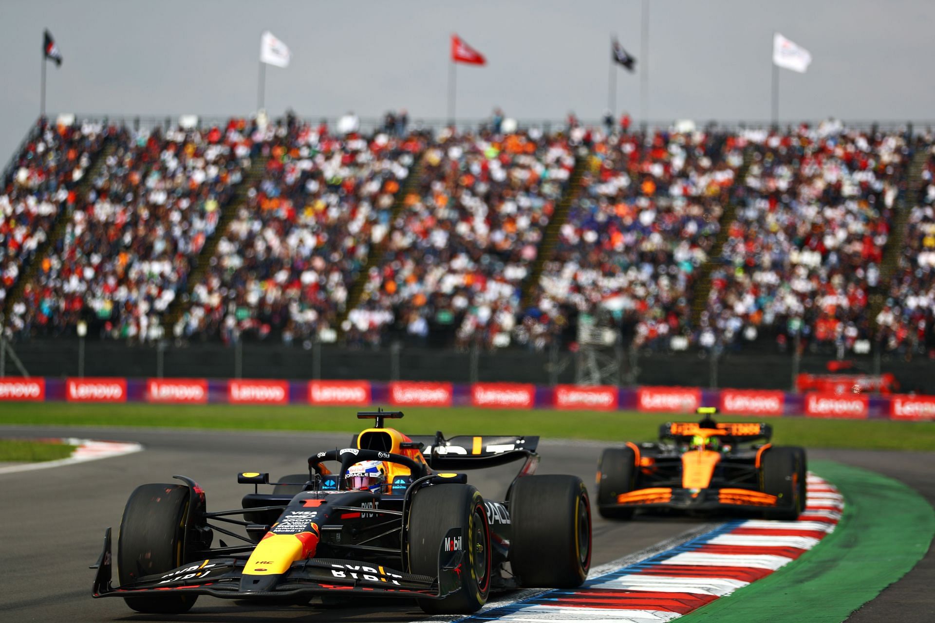 Max Verstappen (1) of Oracle Red Bull Racing RB20 leads Lando Norris (4) of McLaren MCL38 | Getty Images