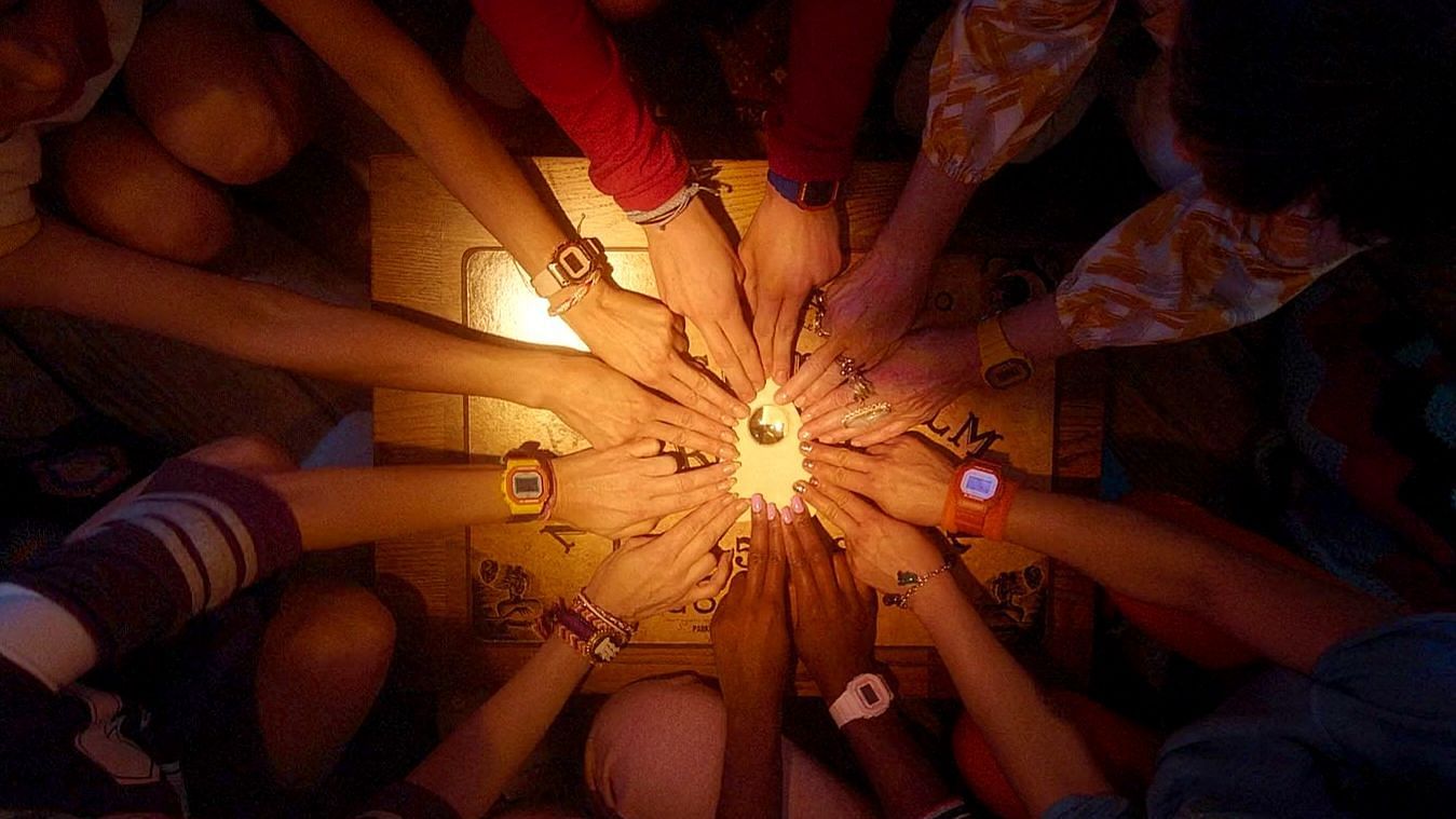 A still of the coven using an Ouija Board from Agatha All Along (via Marvel Studios / YouTube)