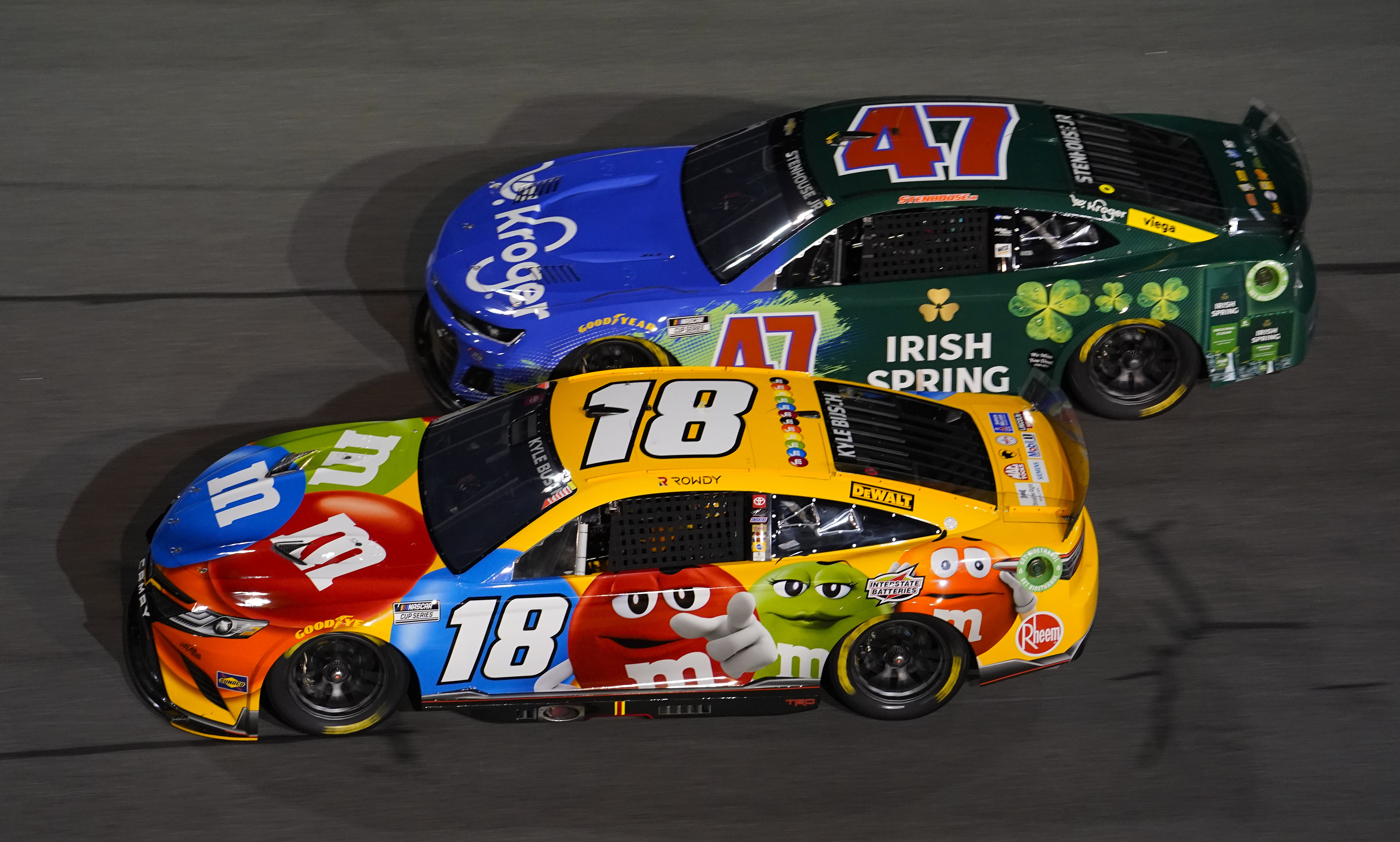 Kyle Busch (18) and driver Ricky Stenhouse Jr. (47) race side by side during the Bluegreen Vacations Duel 2 at Daytona International Speedway. Mandatory Credit: Mike Dinovo-Imagn Image