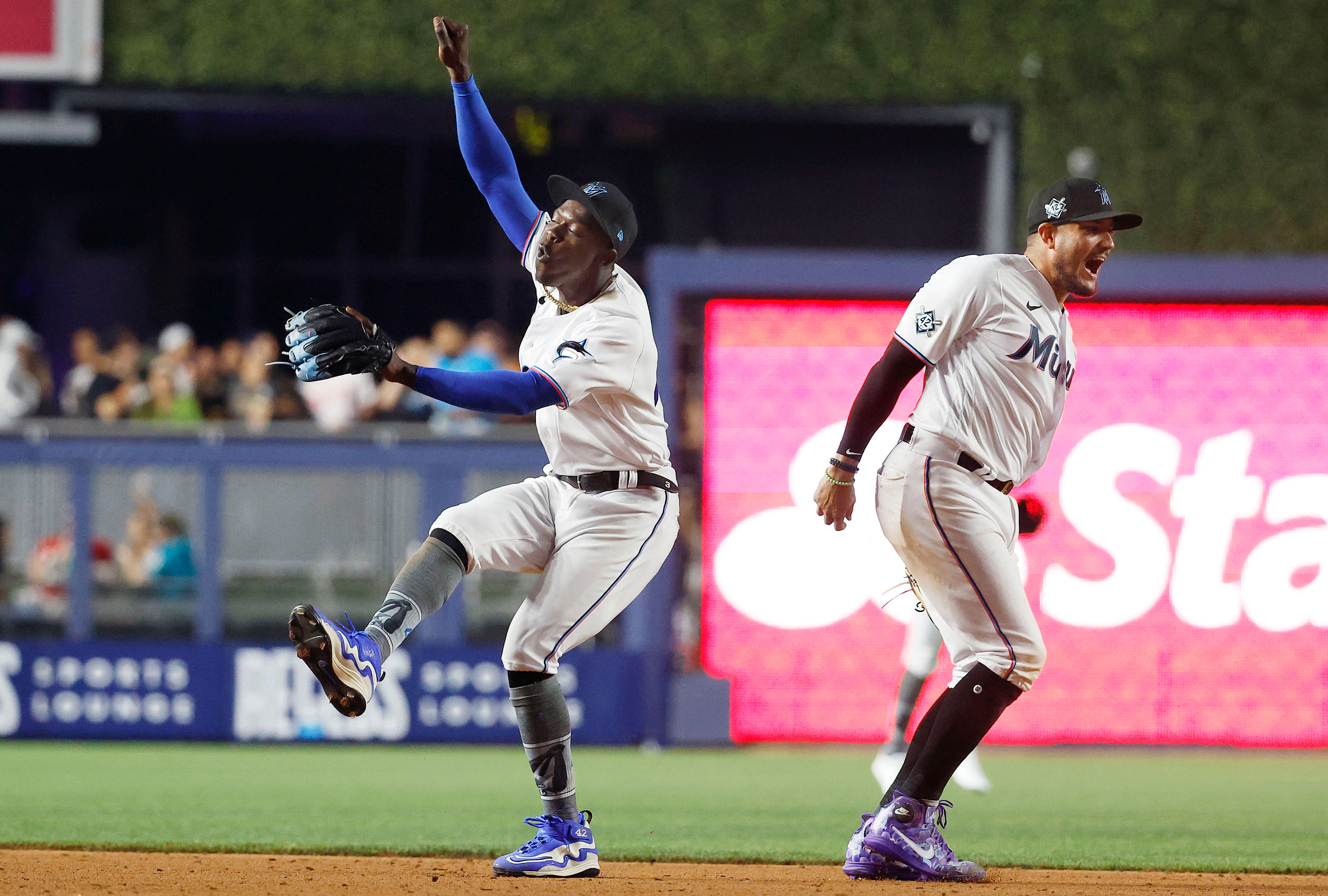 Former Miami Marlins - Jazz /Chisholm Jr. and Miguel Rojas (Photo via IMAGN)