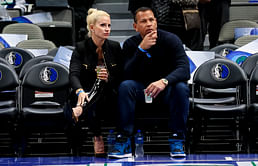 Alex Rodriguez and girlfriend Jaclyn Cordeiro walk hand in hand in color-coordinated outfits at Timberwolves game