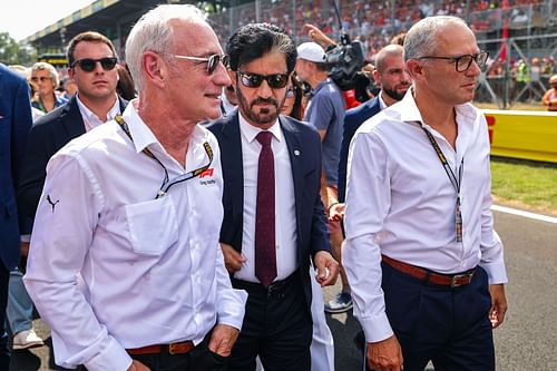 Stefano Domenicali, CEO of the Formula One Group, Mohammed ben Sulayem, FIA President and CEO of Liberty Media Greg Maffel walk on the grid during the F1 Grand Prix of Italy - Source: Getty Images