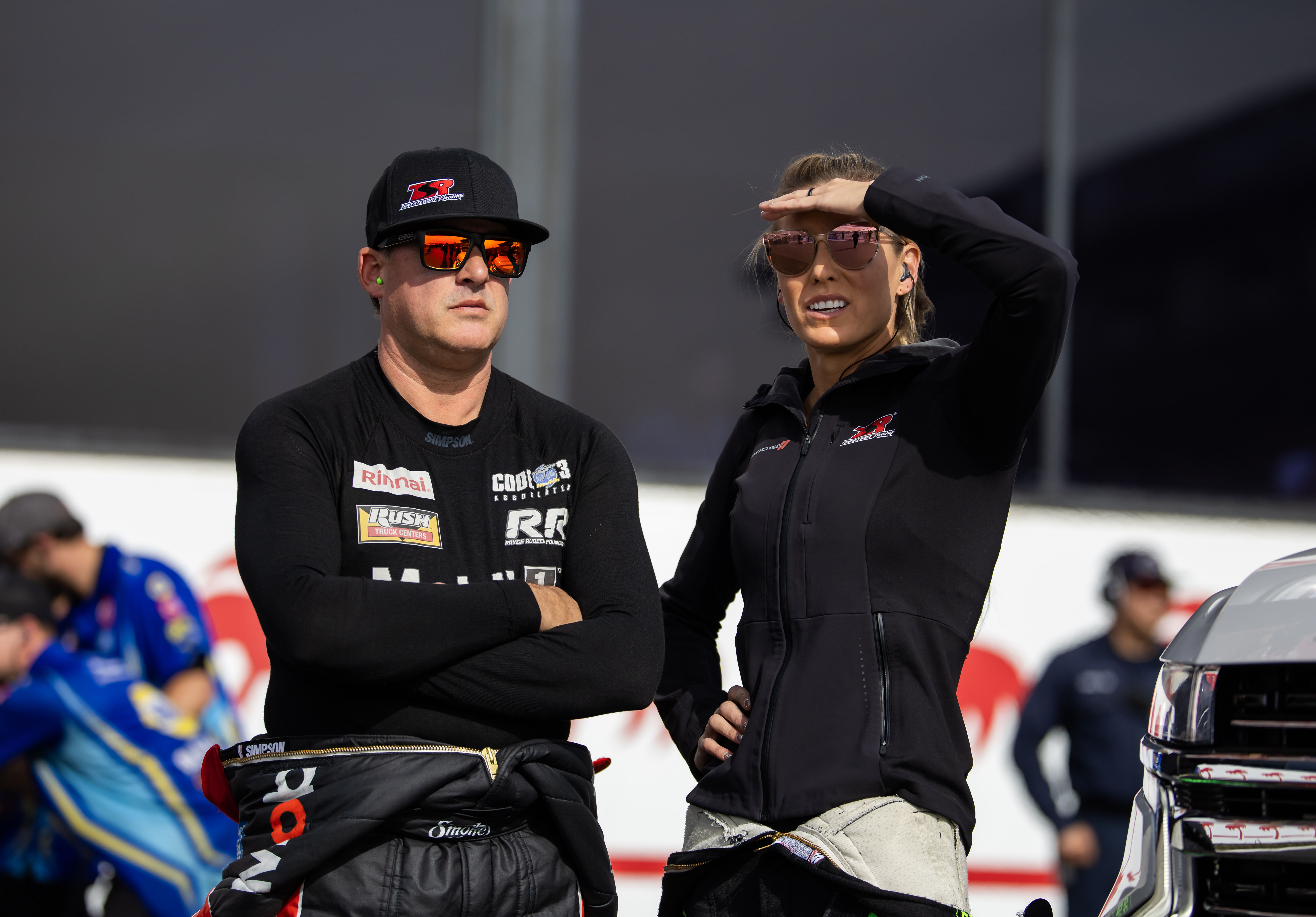 NHRA top alcohol dragster driver Tony Stewart (left) with wife top fuel driver Leah Pruett (right) during qualifying for the NHRA Finals at In-N-Out Burger Pomona Dragstrip. - Source: Imagn