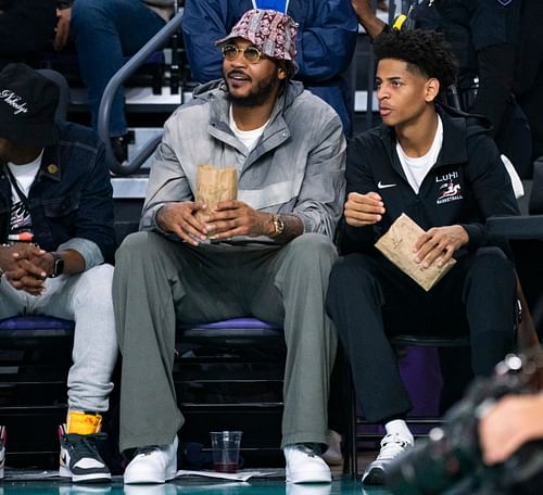 Carmelo and Kiyan Anthony watching a game together - (Source: Imagn)