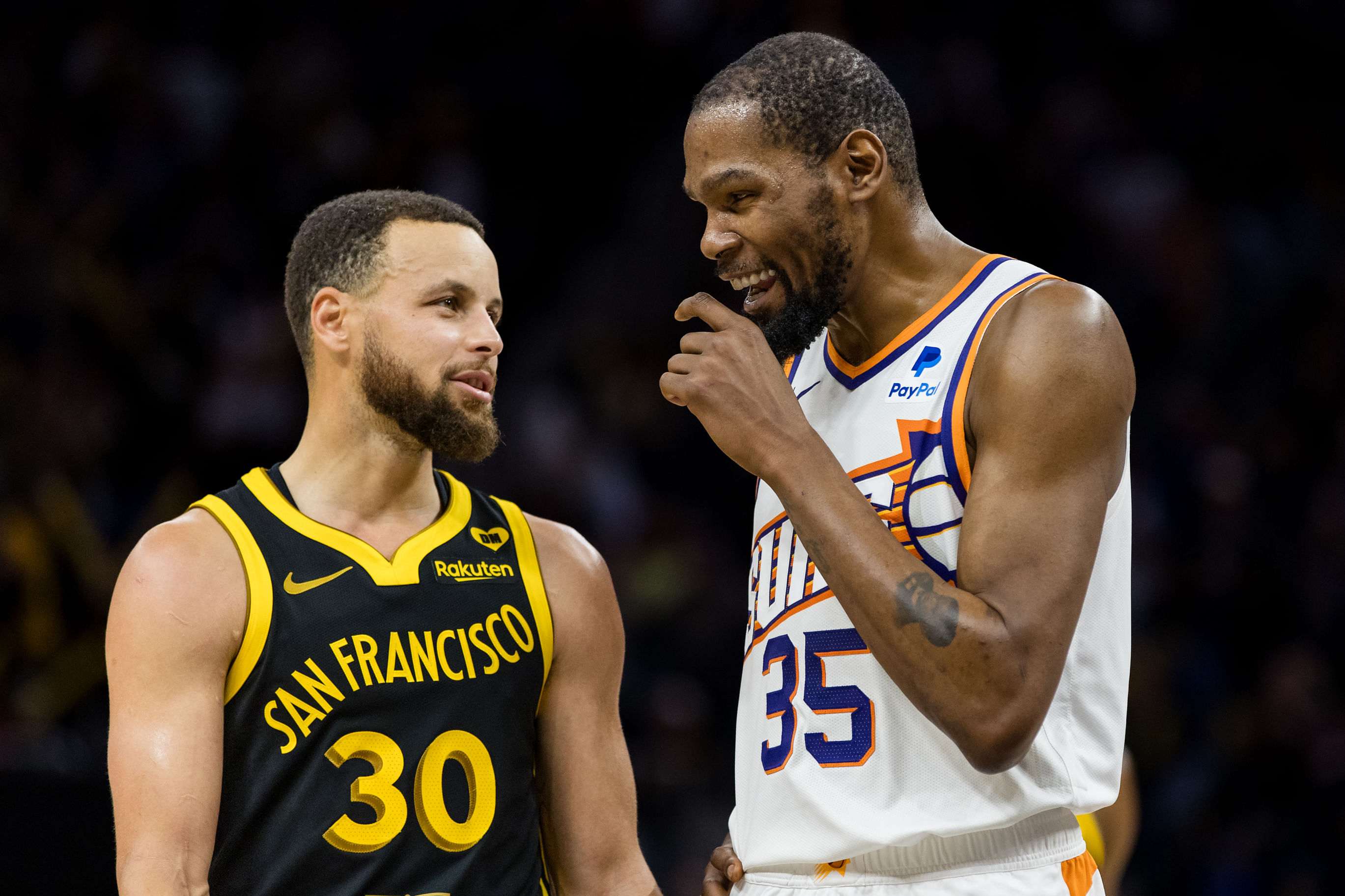 Golden State Warriors guard Stephen Curry and Phoenix Suns forward Kevin Durant talk during the second half at Chase Center. Photo Credit: Imagn