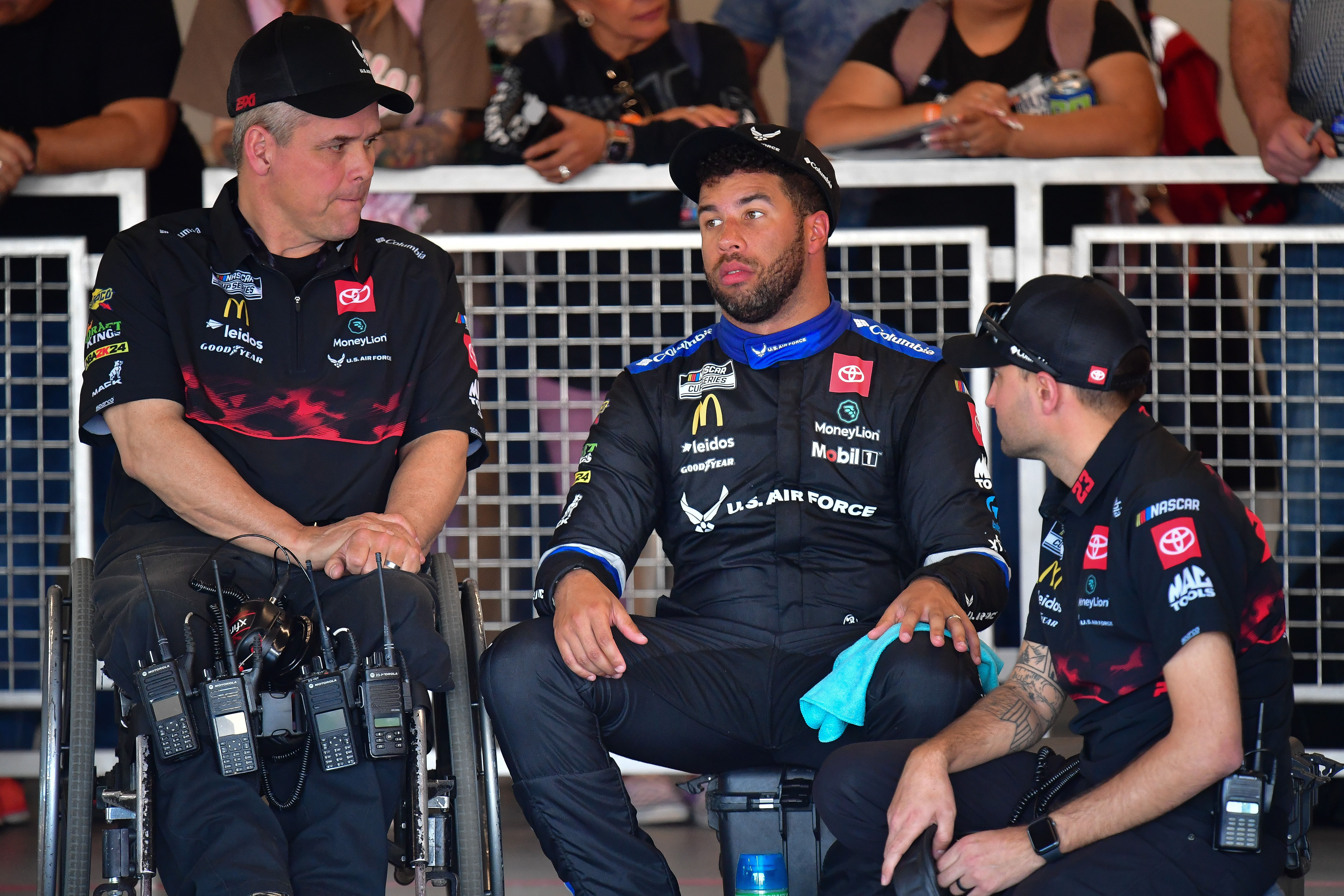 Bubba Wallace (middle) with one of his crew members and crew chief Bootie Barker (left) during Cup Series practice at Phoenix Raceway. - Source: Imagn