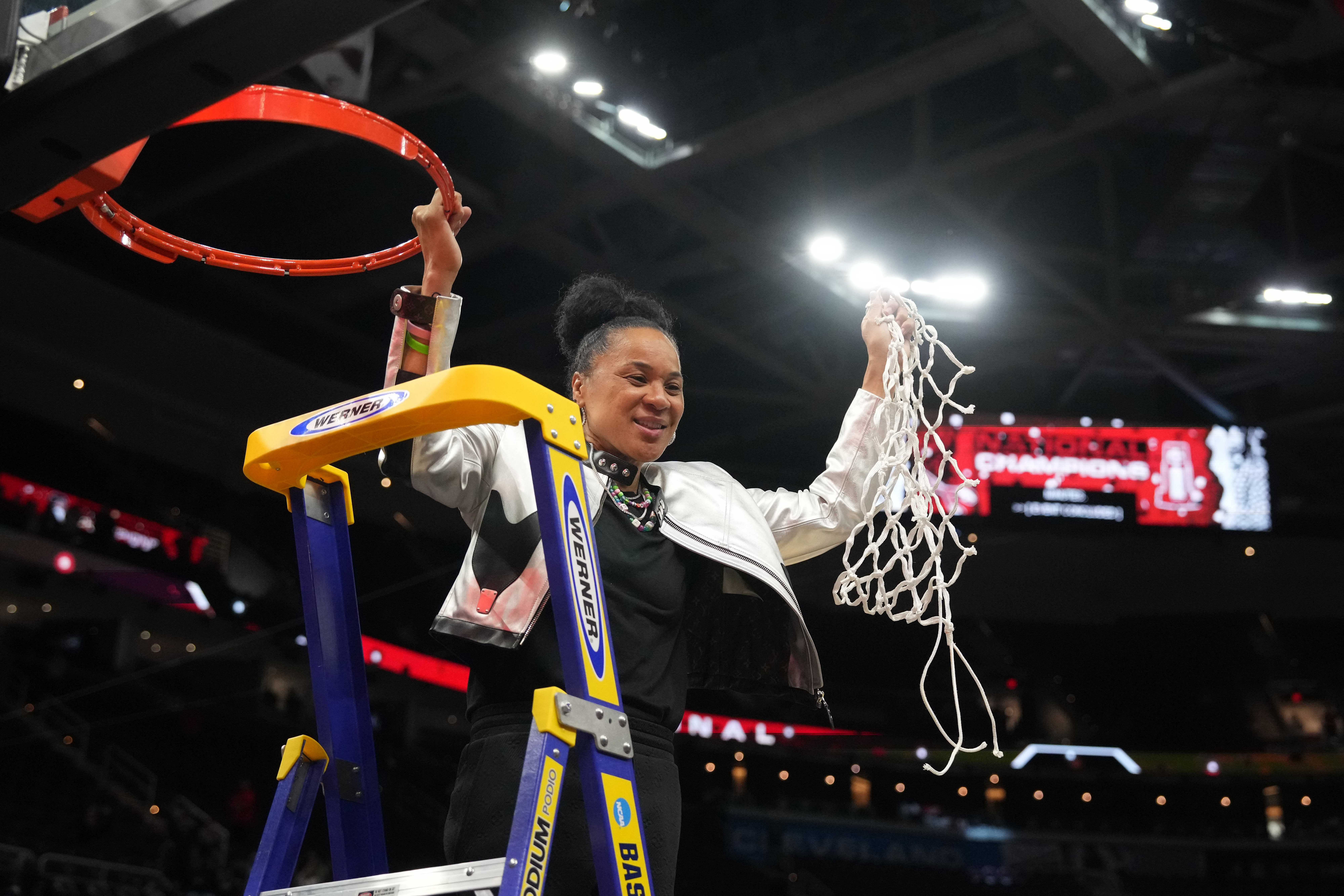 South Carolina coach Dawn Staley cuts down the net after leading the Gamecocks to the 2024 NCAA Tournament title. Photo: Imagn