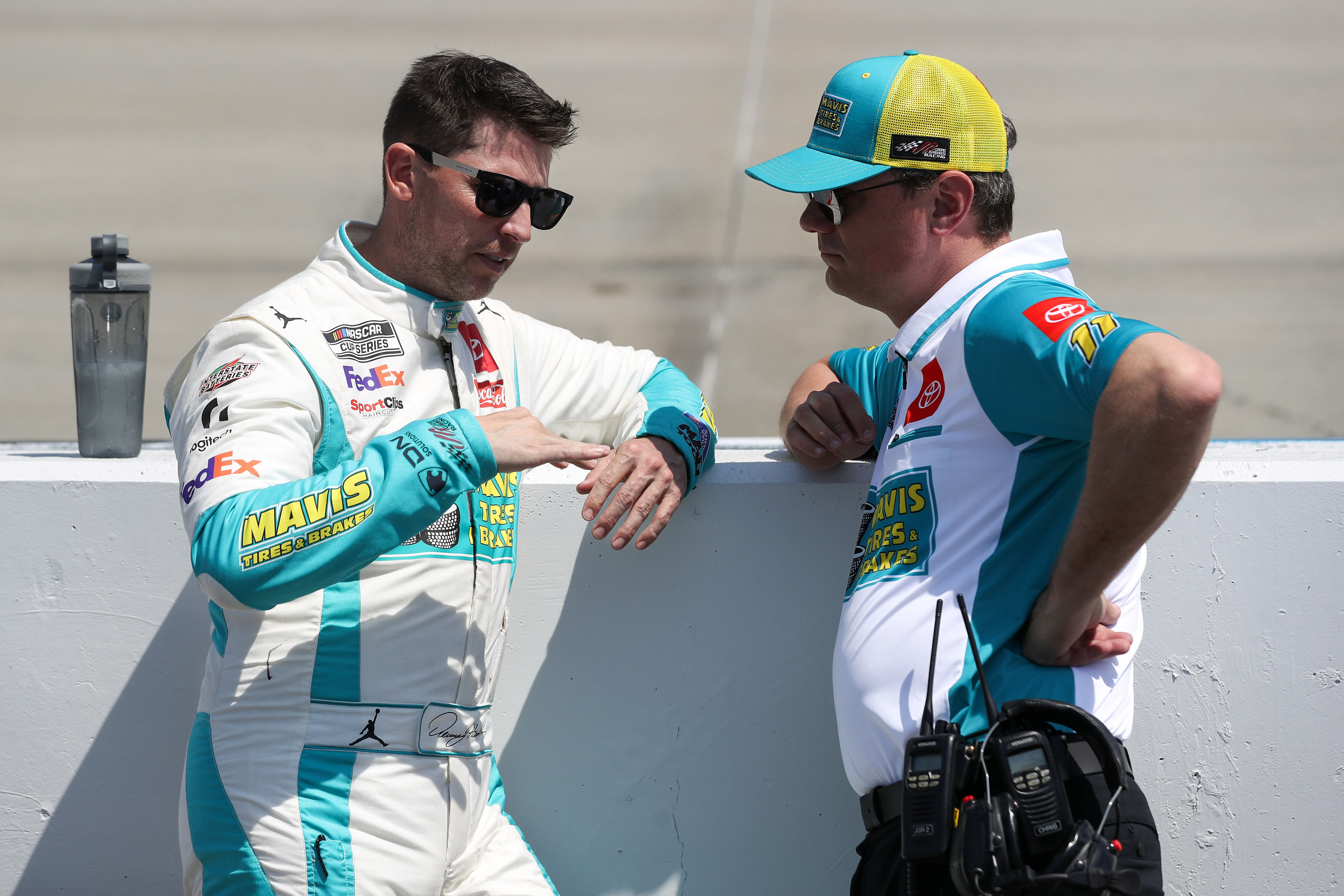 Denny Hamlin (left) chats with crew chief Chris Gabehart (right) on pit road prior to the Wurth 400 at Dover Motor Speedway (Source: Imagn Images)