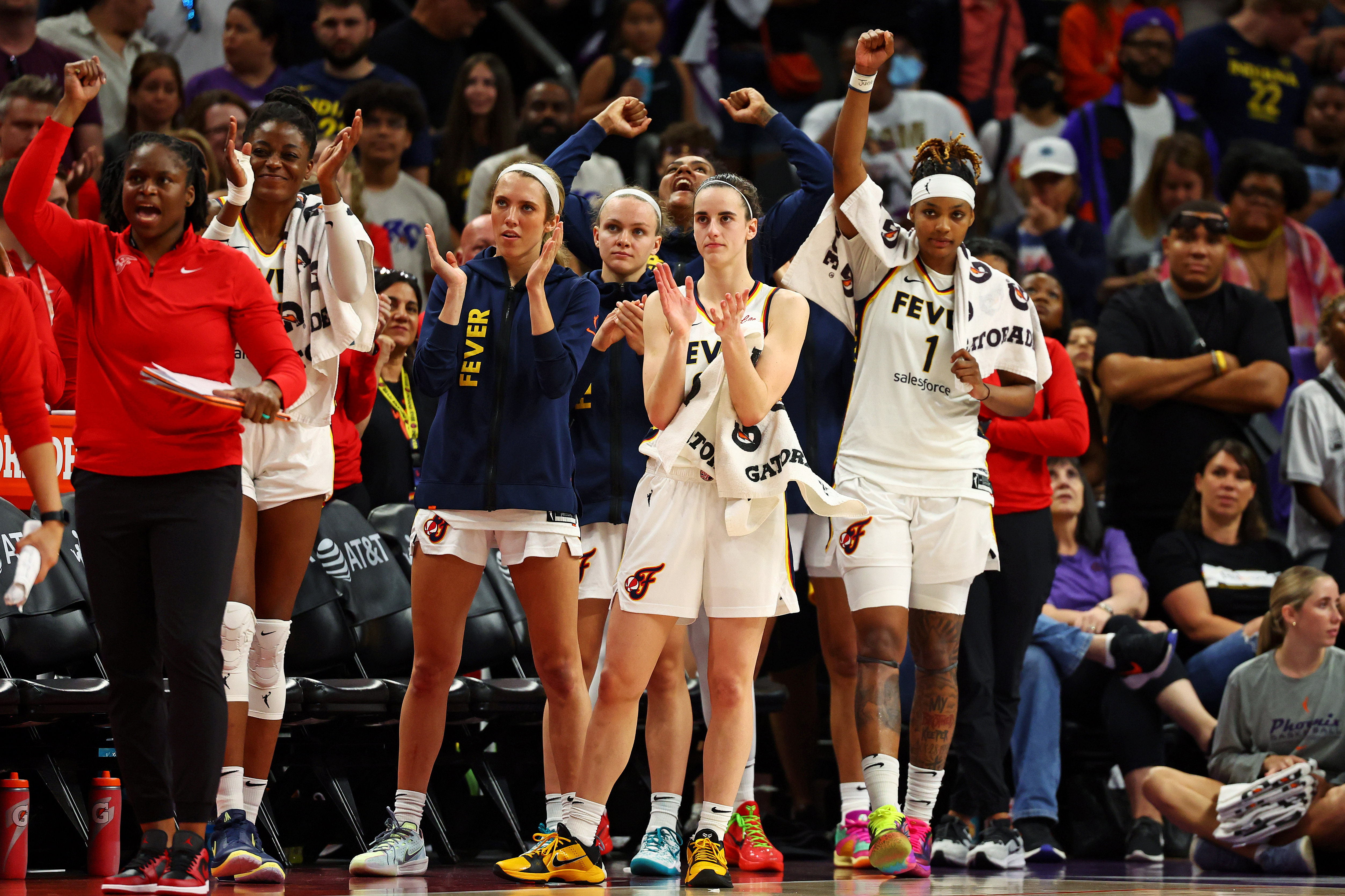 Indiana Fever guard Caitlin Clark and forward NaLyssa Smith react from the bench at Footprint Center. Photo Credit: Imagn