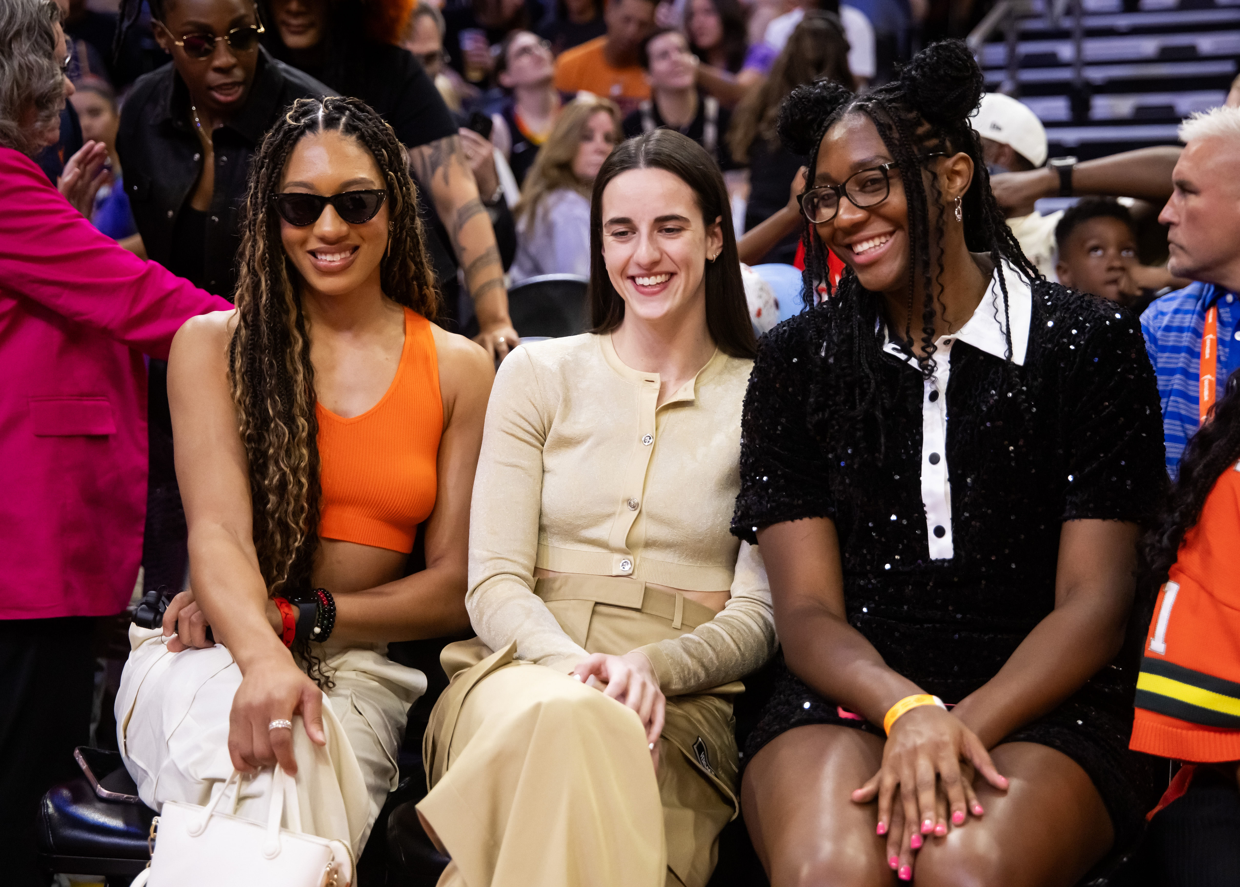 WNBA All-Stars Aerial Powers, Caitlin Clark and Aliyah Boston look on from the sidelines during the WNBA All-Star Skills Night at the Footprint Center. Photo Credit: Imagn