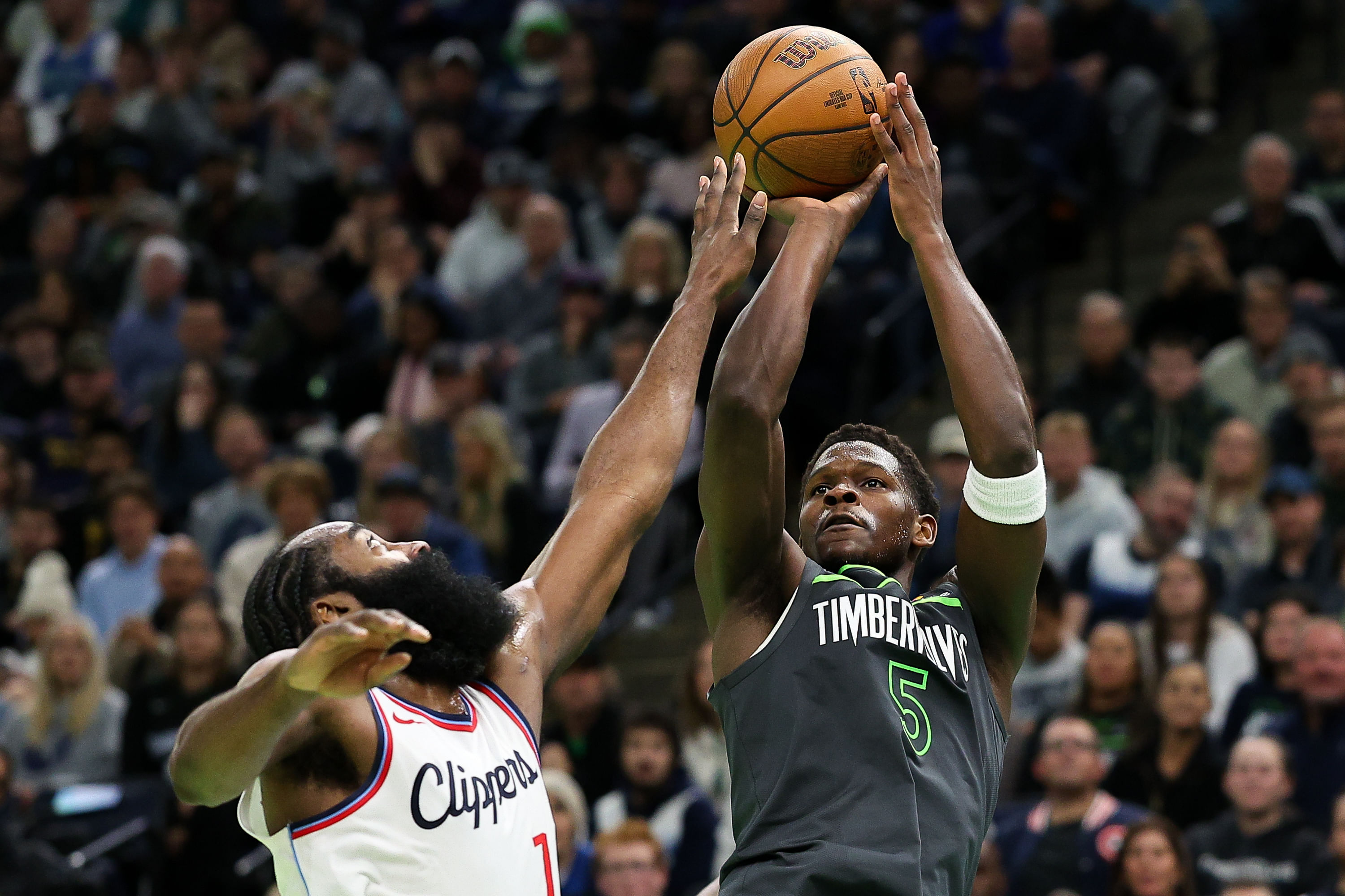 Nov 29, 2024; Minneapolis, Minnesota, USA; Minnesota Timberwolves guard Anthony Edwards (5) shoots as LA Clippers guard James Harden (1) defends during the second half of an NBA Cup game at Target Center. Mandatory Credit: Matt Krohn-Imagn Images - Source: Imagn