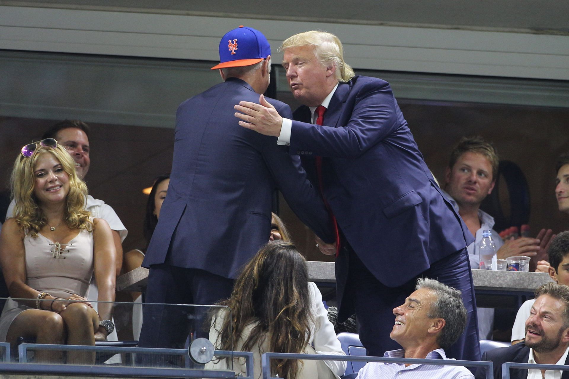 Donald Trump meets John McEnroe (in cap) at US Open 2015