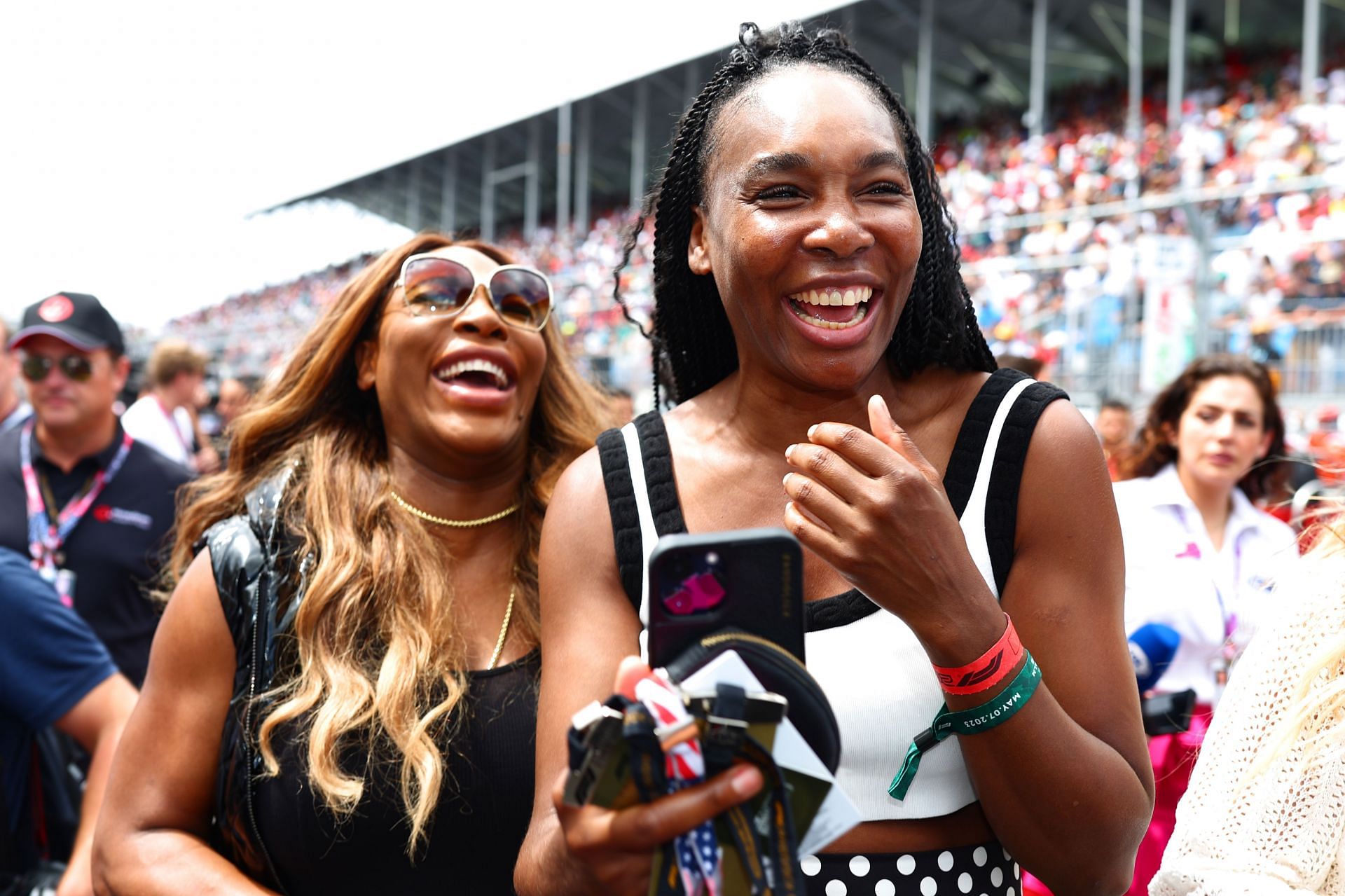 Three-time Olympic gold medalists together, Serena Williams (L) and Venus Williams at the Miami GP | via Getty Images